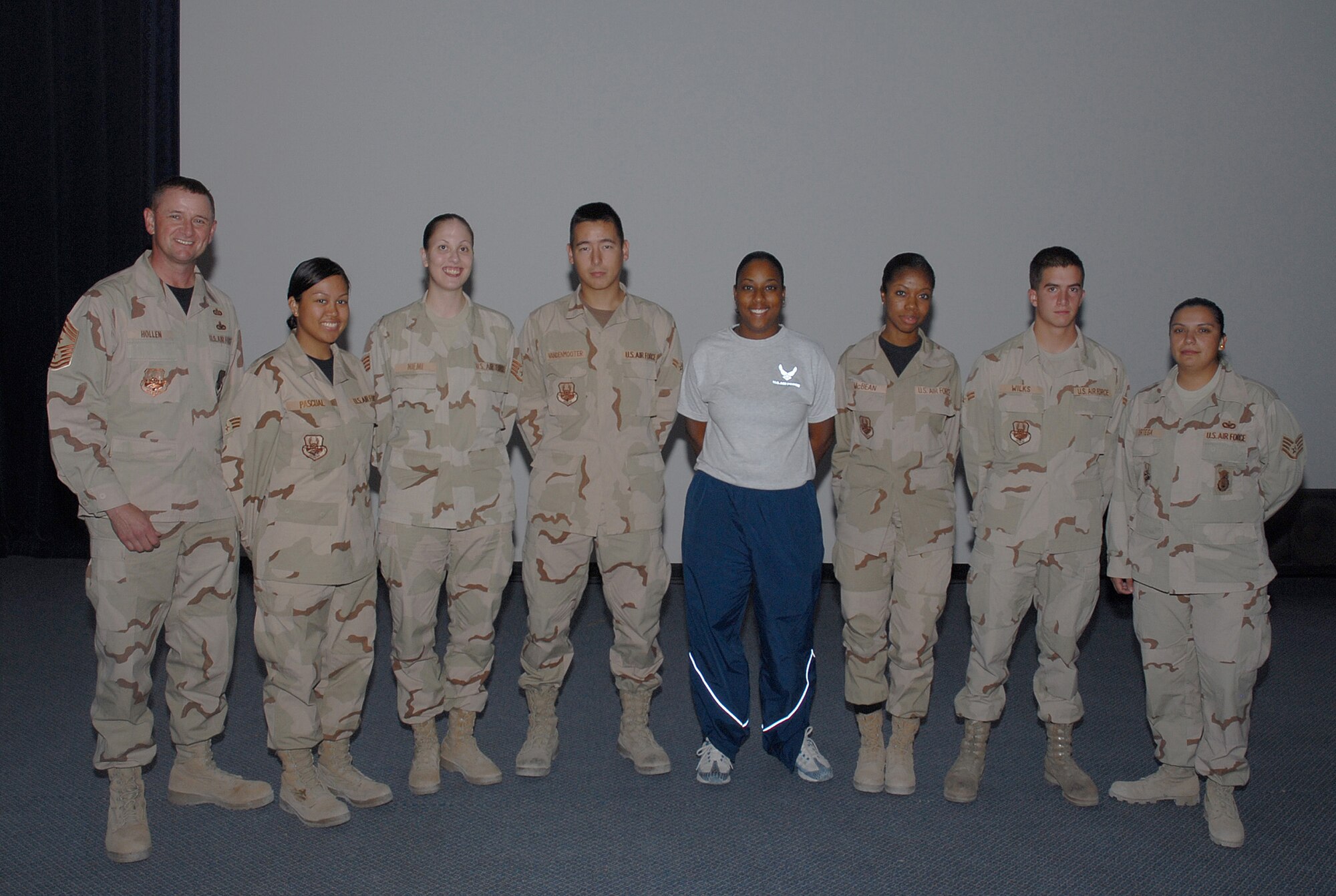 SOUTHWEST ASIA - Desert 5 Scholarship winners were presented their awards Nov. 1. From left to right Presenter, Command Chief Master Sgt. Lloyd Holland, award winners, Senior Airman Nikky Pascual, Staff Sgt. Lauren Niemi, Airman 1st Class Sandy Vandenmooter, Airman 1st Class Chastity Conner, Staff Sgt. Ronette McBean, Airman 1st Class Sandy Robert Wilks, and Desert 5 President, Staff Sgt. Penny Ortega. The Desert 5 awards one scholarship every month. This month the organization was able to award six winners due to a generous donation from the Desert Chiefs. Next month the Desert 5 will be awarding four scholarships because of another generous donation from Maj. Katharine Barber. (United States Air Force photo/Staff Sgt. Douglas Olsen)