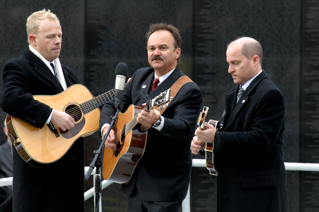 Singer and songwriter Jimmy Fortune, center, sings "More Than a Name on The Wall" while band members Jamie Dailey and Darrin Vincent play guitar during the Vietnam Veterans Memorial 25th Anniversary Reading of Names in Washington, D.C., Nov. 7, 2007. 