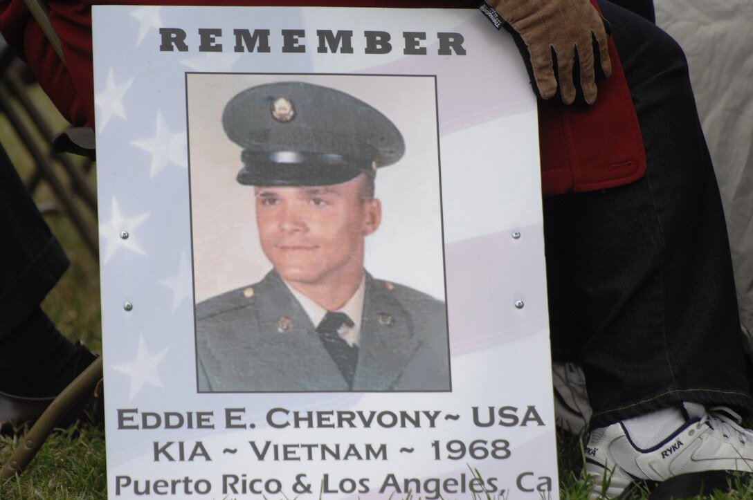 A woman holds a sign with an image of an American soldier killed in action in the Vietnam War during the  Vietnam Veterans Memorial 25th Anniversary Reading of Names in Washington, D.C., Nov. 7, 2007. 