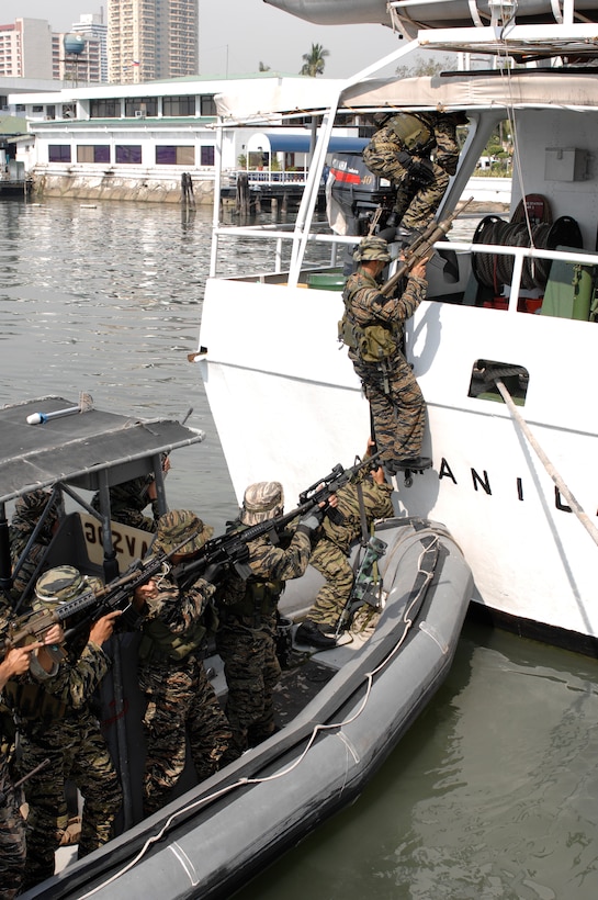 A Republic of the Philippines Navy Seal Team boards a mock hijacked vessel during a demonstration for members of the 74th Joint Civilian Orientation Conference at the Philippine Naval Headquarters in Manila, Nov. 8, 2007. 