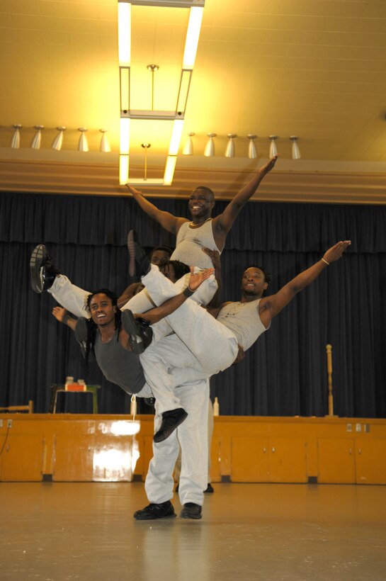 VANDENBERG AIR FORCE BASE, Calif. -- One of the Famous Africa Acrobats LLC., carries four others in an acrobatic balancing act during a show at Crestview Elementary on Nov. 8. Performances included the limbo, jump roping, summersaults, and human pyramids. (U.S. Air Force photo/Airman 1st Class Cole Presley) 