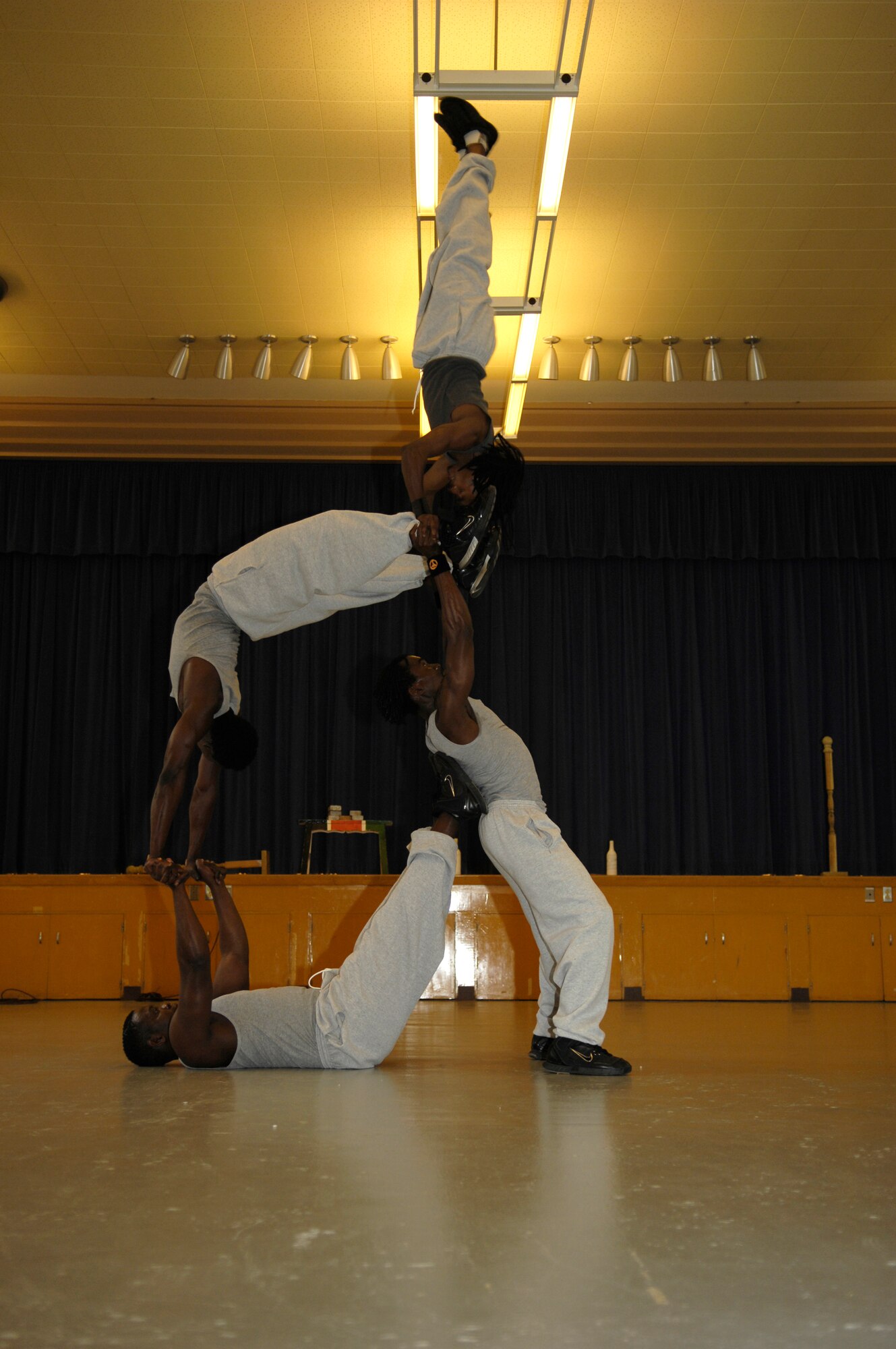 VANDENBERG AIR FORCE BASE, Calif. -- Members of Famous Africa Acrobats LLC. use leverage and strength to perform stunning feats of balance at Crestview Elementary on Nov. 8.  Performances included the limbo, jump roping, summersaults, and human pyramids.  (U.S. Air Force photo/Airman 1st Class Cole Presley)