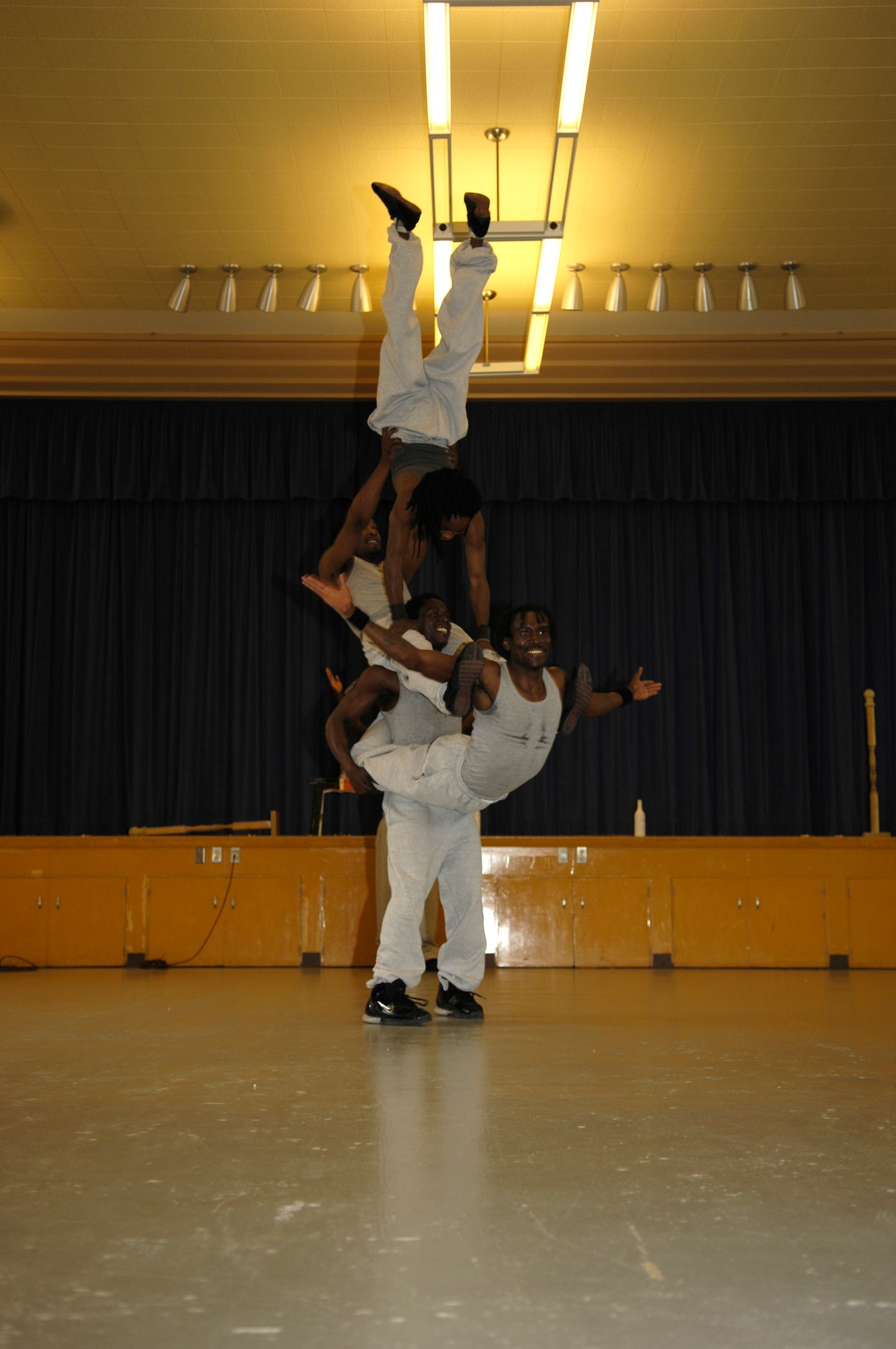 VANDENBERG AIR FORCE BASE, Calif. -- One of the Famous Africa Acrobats LLC., carries four others in an acrobatic balancing act during a show at Crestview Elementary on Nov. 8.  Performances included the limbo, jump roping, summersaults, and human pyramids. (U.S. Air Force photo/Airman 1st Class Cole Presley)
