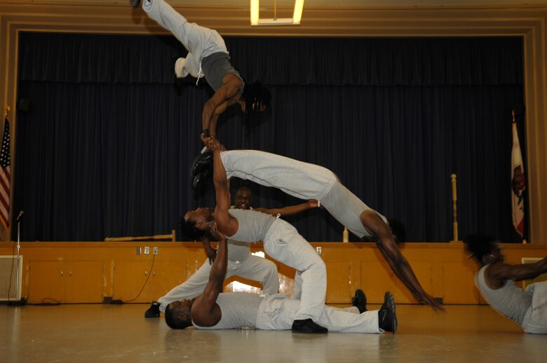 VANDENBERG AIR FORCE BASE, Calif. -- Members of Famous Africa Acrobats LLC., build a tall human ring while other members dive through the structure, during a show at Crestview Elementary on Nov. 8.  Performances included the limbo, jump roping, summersaults, and human pyramids.  (U.S. Air Force photo/Airman 1st Class Cole Presley)