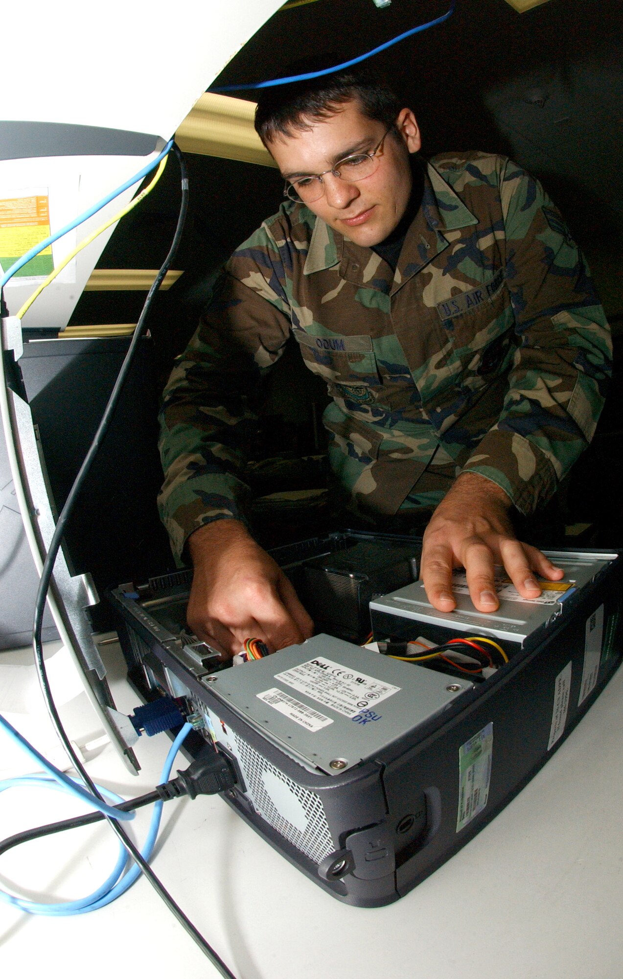 Senior Airman Jonathan Odum repairs a computer that will eventually go on the Andersen Air Force Base, Guam, computer network.  He is deployed from the Ohio Air National Guard's 121st  Air Refueling Wing and assigned to 36th Communications Squadron. Airman Odum is part of a special group of Airmen that are charged with the critical task of protecting Andersen's cyberspace against intruders. (U.S. Air Force photo/Senior Airman Brian Kimball) 