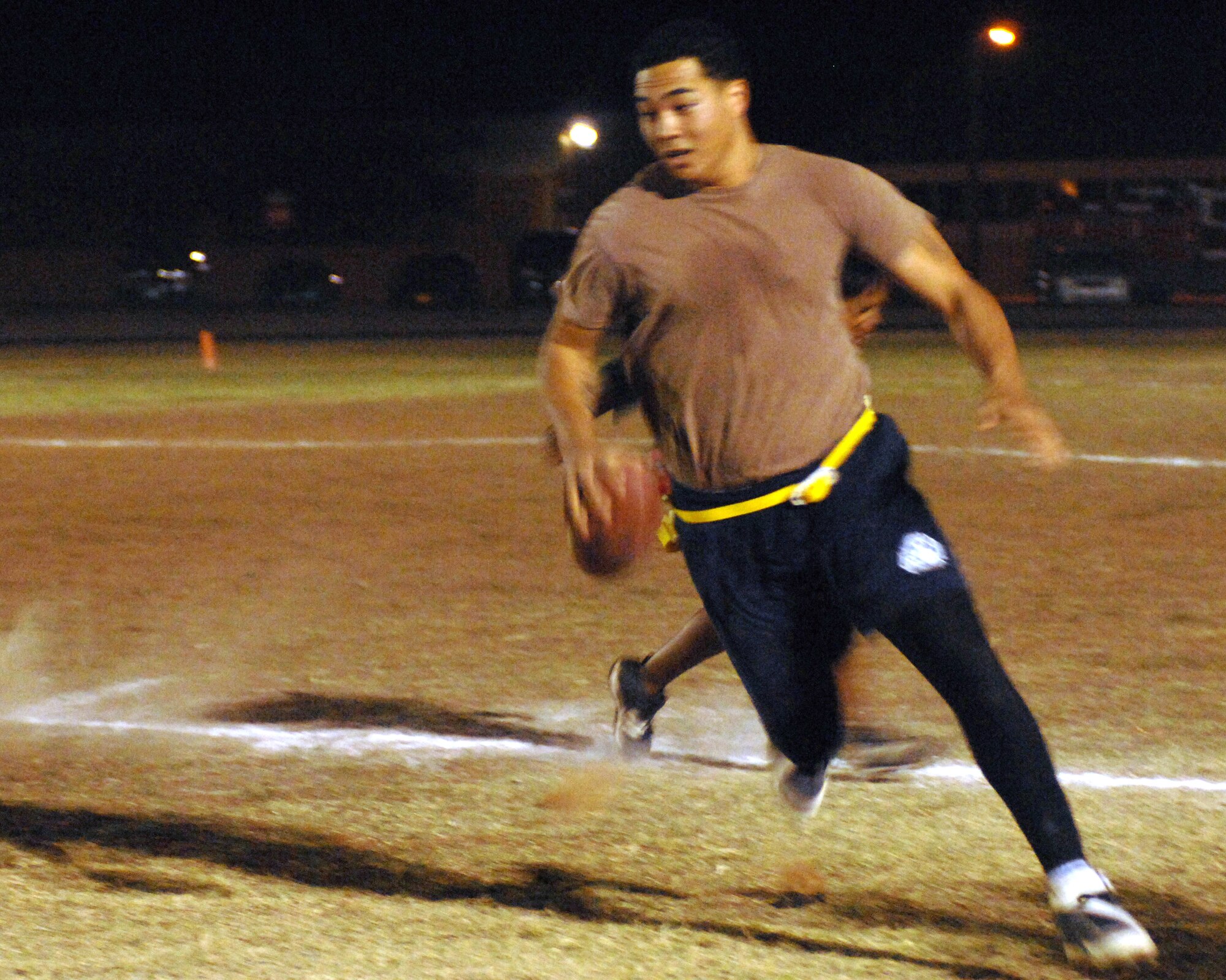 CANNON AIR FORCE BASE, N.M. -- 27th Special Operations Civil Engineering Squadron quarterback Larry Boyd runs downfield in the intramural flag football championship game versus 27th Special Operations Communications Squadron. SOCES won the game in overtime. (U.S. Air Force photo by Airman 1st Class Evelyn Chavez)