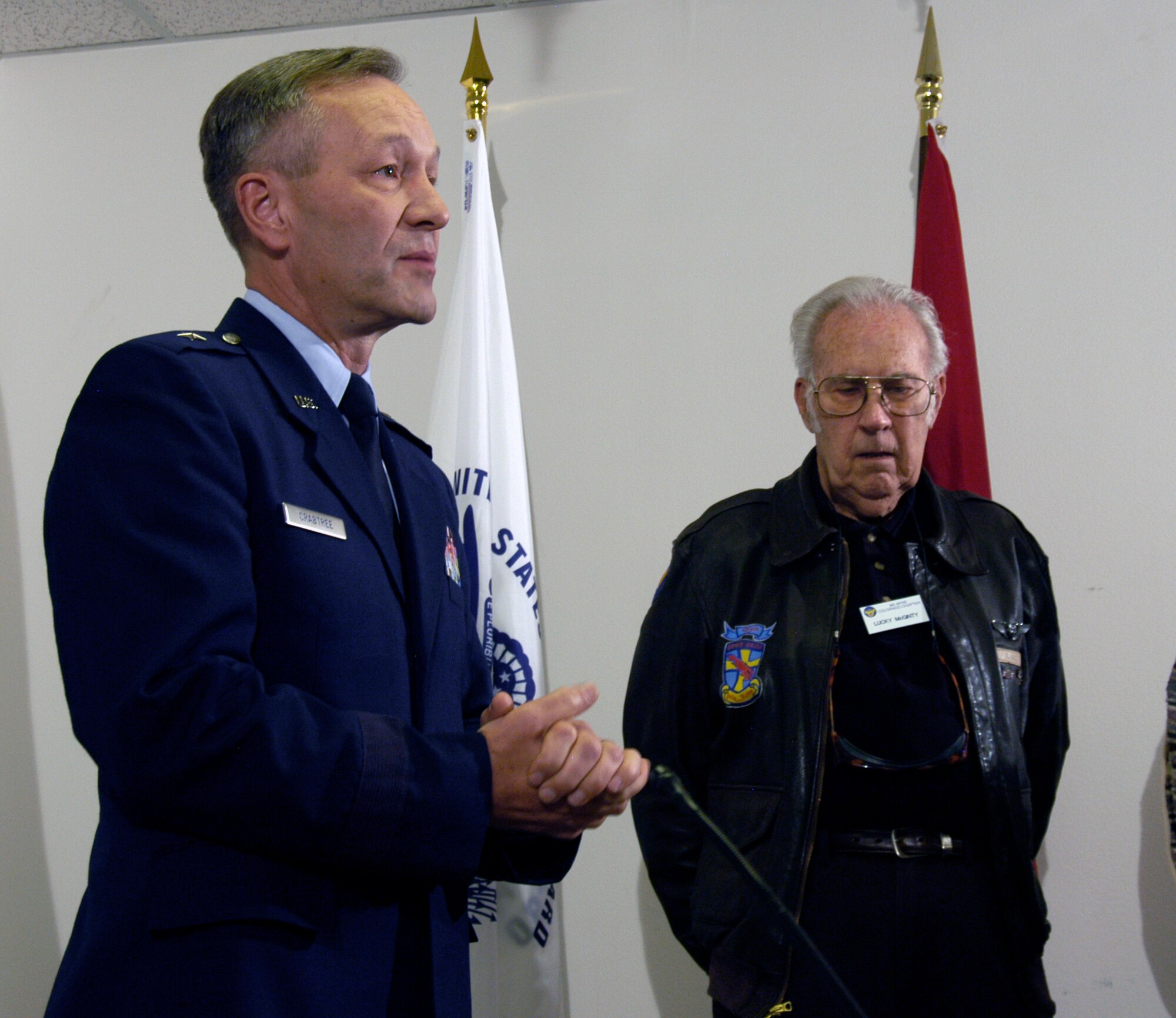 Brig. Gen. Eric Crabtree (left), Air Reserve Personnel Center commander, thanks former Staff Sgt. Elmer McGinty (right) for his service at a ceremony Nov. 9. General Crabtree presented seven medals, including the Distinguished Flying Cross, to Sergeant McGinty at the Greatest Generation Foundation in Denver. Sergeant McGinty never formally received his medals after his service in 1943.