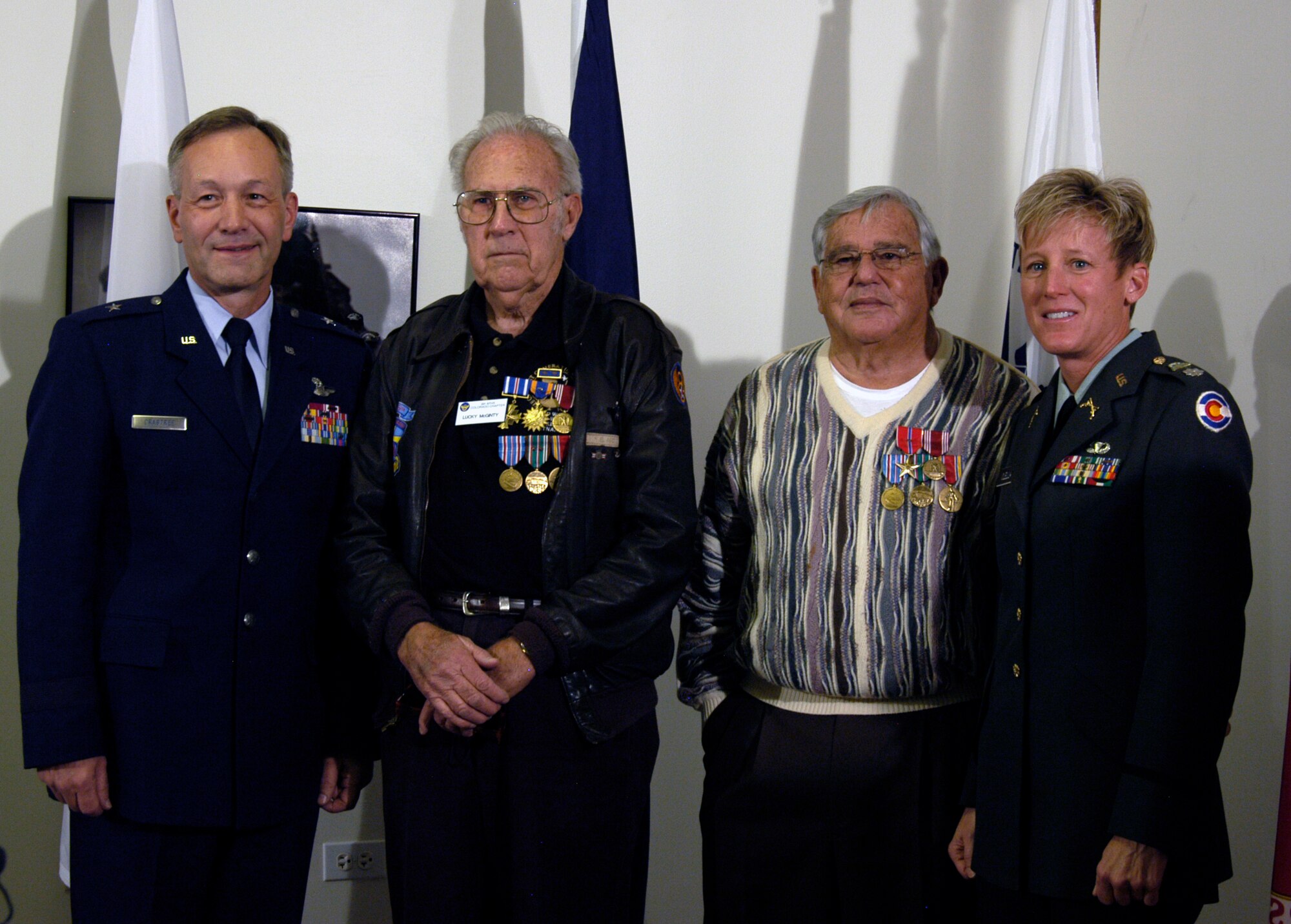 From left, Brig. Gen. Eric Crabtree, Air Reserve Personnel Center commander; former Staff Sgt. Elmer McGinty, former Staff Sgt. Shepp Waldman and Lt. Col. Laura Clellan of the Colorado Army National Guard, pose during the decoration presentation for Sergeants McGinty and Waldman. The two WWII veterans formally received their medals at a ceremony Nov. 9, nearly 64 years after their service.