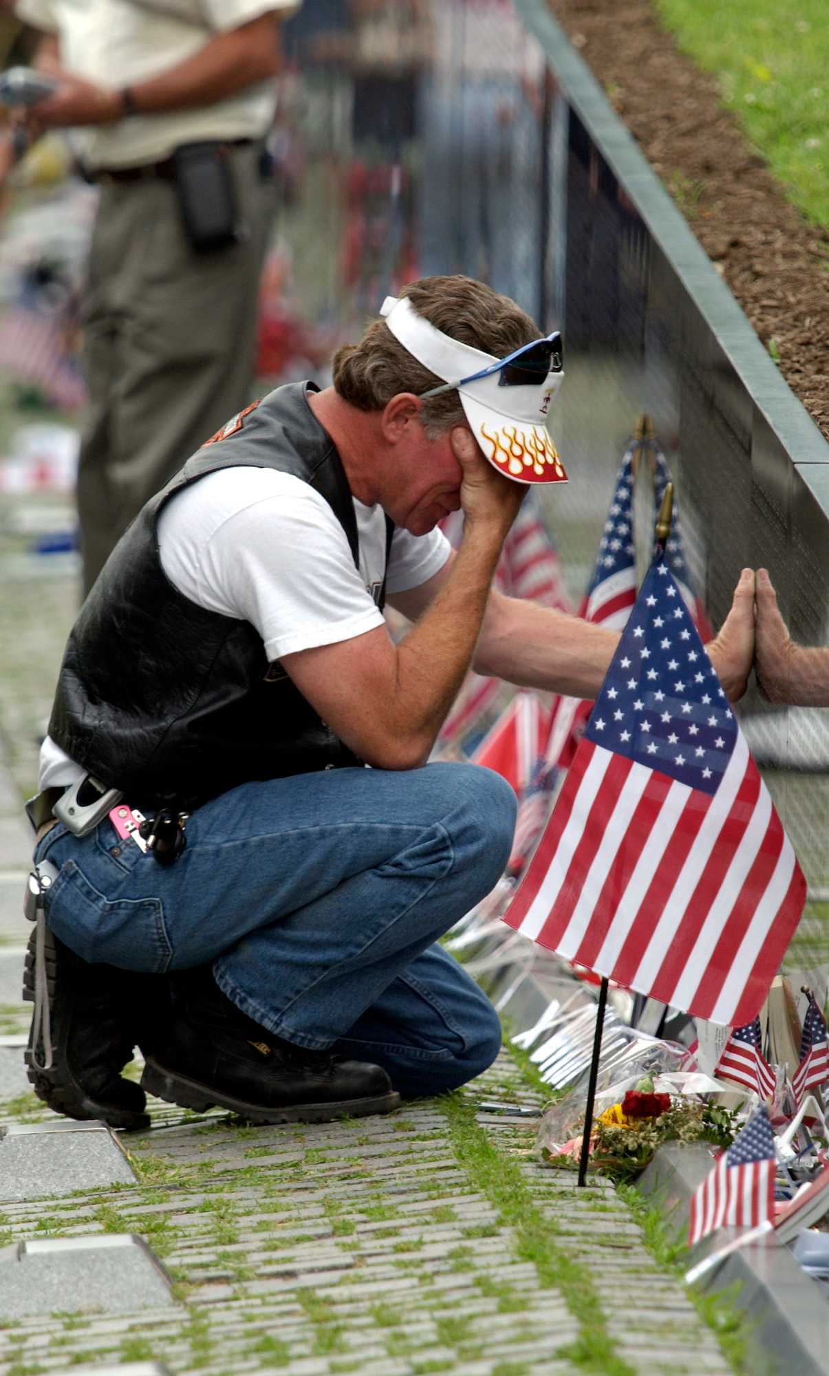 One of the more than 400,000 motorcyclists who participated in the 17th annual Rolling Thunder "Ride for Freedom" to the Vietnam Veterans Memorial in Washington, D.C., breaks down after finding the name of a fallen comrade etched into the black marble of "The Wall," May 30, 2004. Rolling Thunder drew motorcyclists from across the country to gather at the Pentagon and ride across the Memorial bridge to the memorial to pay tribute and raise awareness about those who never made it home. The Wall draws hundreds of thousands of visitors a year. Many leave tributes in honor of the more than 58,000 names carved into the memorial.   (U.S. Air Force/Master Sgt. Jim Varhegyi)
