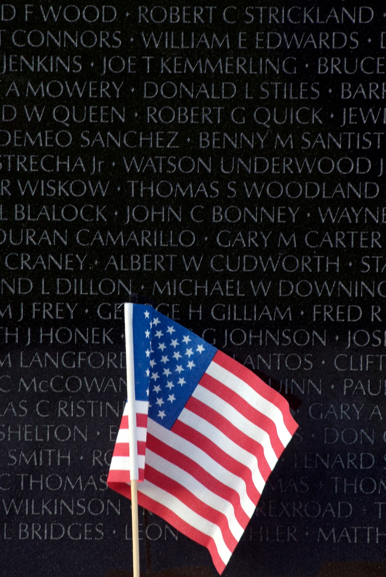 Mementos such as this U.S. flag were left all along the  "The Wall" following opening ceremonies commemorating the 20th anniversary of the Vietnam Veterans Memorial on the Mall in Washington, D.C., Nov. 7, 2002.  The opening ceremony kicked off a four day event where volunteers read all 58,229 names inscribed on "The Wall" of service members killed during the Vietnam conflict.  (U.S. Air Force photo/Tech. Sgt. Jim Varhegyi)