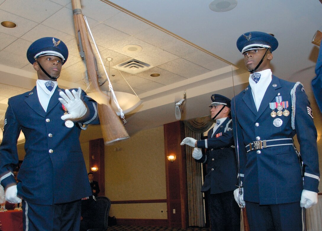 Senior Airman Micael Jiggetts, Staff Sgt. Jason Martin and Staff Sgt Theodore Miller of the U.S. Air Force Honor Guard perform rifle drills during the Base Honor Guard Awards Ceremony at The Andrews Club on Oct. 30. (US Air Force/A1C Renae Kleckner)