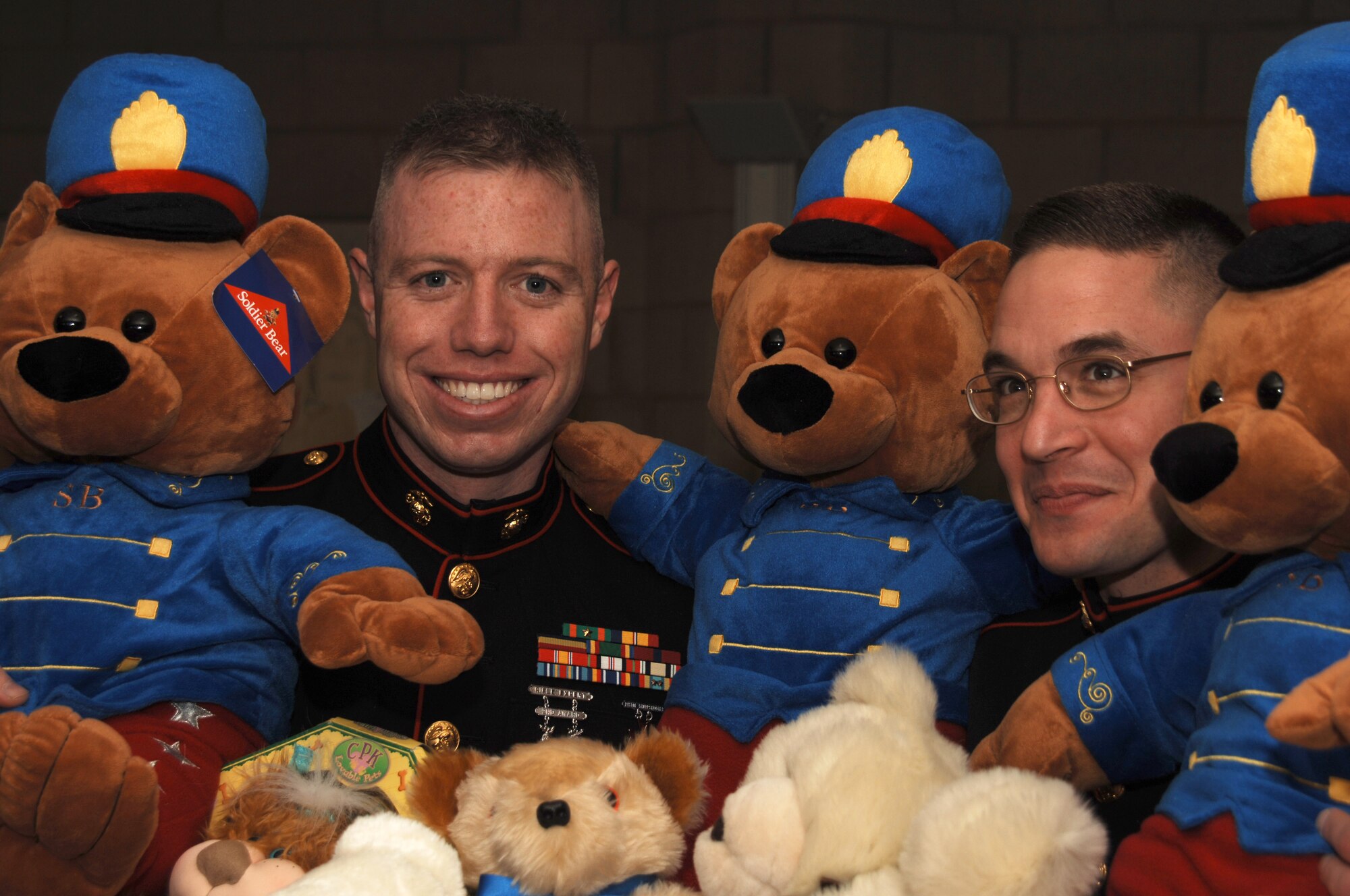 Marine Corps Sergeant Christopher M. Smith and Gunnery Sergeant Joseph C. Guagenti pose with stuffed bears collected during last year's Marine Corps Toys for Tots program.  Collection boxes for donations are located at the Base Exchanges at RAF Alconbury, RAF Lakenheath and RAF Mildenhall.  A box is also located at the NYPD on RAF Molesworth. The program benefits needy children through Cambridgeshire (U.S. Air Force Photo by Staff Sgt Jocelyn Rich)