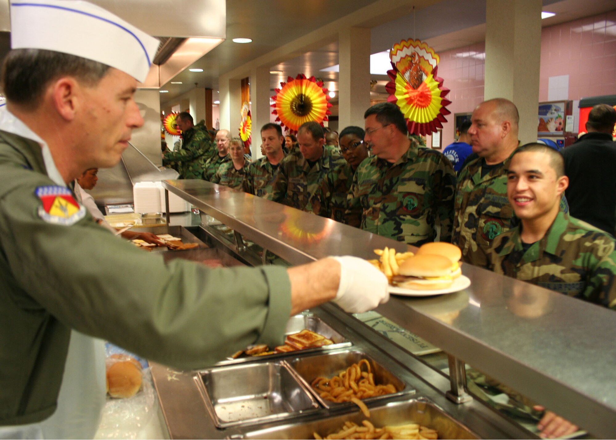 WRIGHT-PATTERSON AFB, Ohio - Brig. Gen. Bruce E. Davis serves Airman First Class Eddie Sanchez, 445th Aerospace Medicine Squadron, during the lunchtime hour at the Pitsenbarger Dining Hall.  Commander's and First Sergeants serve airman during the November and December UTAs to show their appreciation for their service. (U.S. Air Force photo/Senior Airman Ken LaRock)