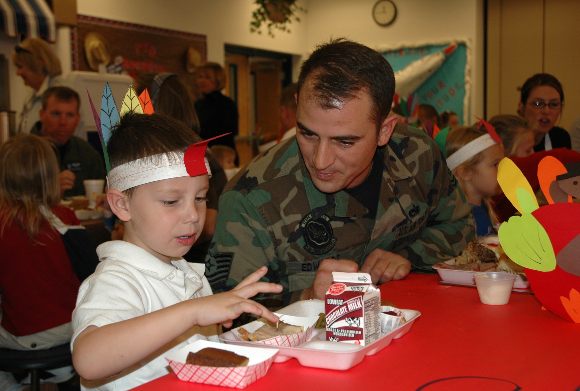 Cody discusses the option of eating turkey with his dad, Tech. Sgt. Mark Edwards, 43rd Aircraft Maintenance Squadron.  On Nov. 8 Tyndall Elementary held its annual Thanksgiving meal at lunch and invited parents to join.  (U.S. Air Force photo/Chrissy Cuttita)
