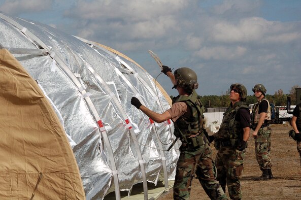Airmen deployed to Air Force Exercise Eagle Flag 08-1 build a tent during operations for the exercise Oct. 23 at Naval Air Engineering Station Lakehurst, N.J.  The exercise, operated by the U.S. Air Force Expeditionary Center's 421st Combat Training Squadron, tests and trains Airmen in expeditionary combat support skill sets.  (U.S. Air Force Photo/Tech. Sgt. Scott T. Sturkol)