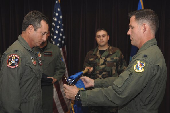 WHITEMAN AIR FORCE BASE, Mo. -- Col. Thomas Berghoff, 53rd Test Management Group commander, from the 53rd Wing, Eglin Air Force Base, Fla., watches as Lt. Col. Robert Tomasino unravels a new flag representing Detachment 2's activation here Nov. 6. Colonel Tomasino is the first commander for the newly formed Det. 2, 53rd TMG. The detachment determines effectiveness and suitability of new weapon systems and develops future combat employment techniques. The 53rd TMG also maintains computer systems critical to electronic warfare software and is responsible for worldwide simulator certification for 176 aircrew training devices. (U.S. Air Force photo/ Airman 1st Class Jessica M. Snow)

