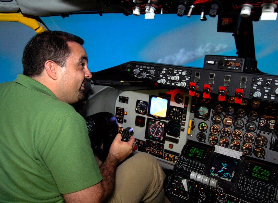 Alfredo Mesa, vice president of Dutko Worldwide in Coral Gables, Fla., leans in to a right bank while flying a KC-135 Stratotanker flight simulator during a 74th Joint Civilian Orientation Conference session on Kadena Air Base, Okinawa, Nov. 9, 2007.  