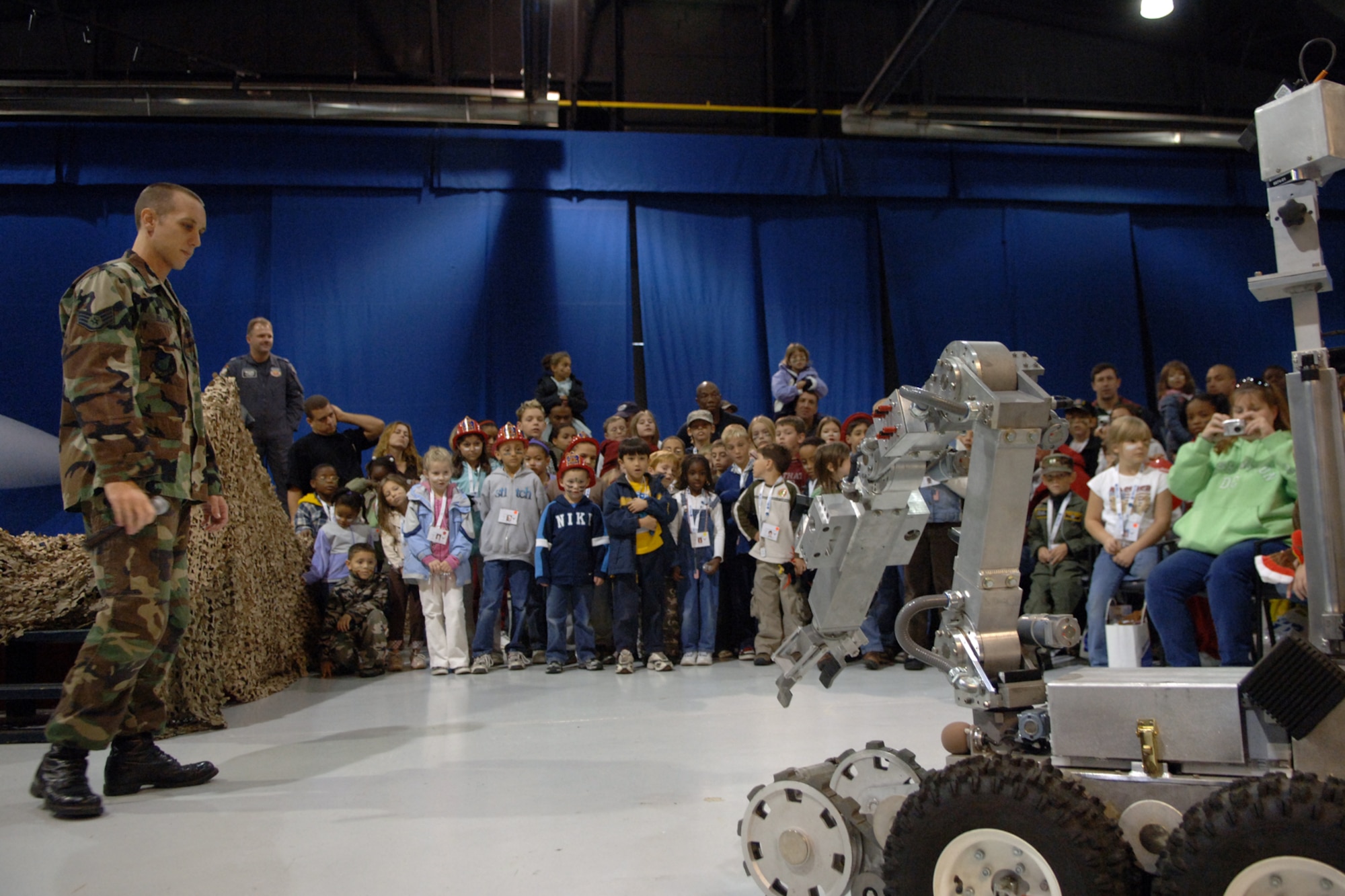 LANGLEY AIR FORCE BASE, Va.--Staff Sergeant Frank Blair, 1st Civil Engineer Squadron, educates military children about the F-6 Alpha Robot that is currently being used in the Global War on Terror.  Many of the children have parents who are currently deployed.  (U.S. Air Force photo/Airman 1st Class Vernon Young)