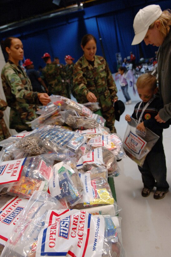 LANGLEY AIR FORCE BASE, Va.--Staff Sergeant Aviva Reinhardt, 1st Civil Engineer Squadron, reaches for a mini deployment bag with her son Andrew during Operation Hero. Operation Hero is a program to educate military children about deployments.  (U.S. Air Force photo/Airman 1st Class Vernon Young)