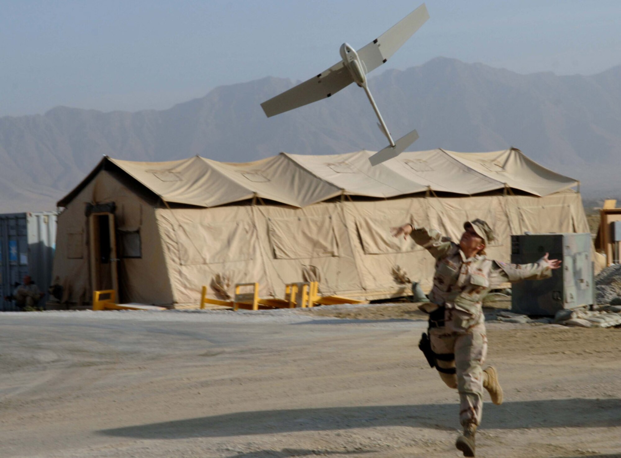 BAGRAM AIR BASE, Afghanistan -- Staff Sgt. Marie Garcia of the 455th Air Expeditionary Wing Force Protection Aerial Surveillance System Flight here launches an RQ-11B Raven unmanned aerial vehicle during a demonstration Oct. 23, 2007. The Raven can stay aloft for up to 90 minutes on a single charge and has a range of ten kilometers. (U.S. Air Force photo by Staff Sgt. Mike Andriacco)
