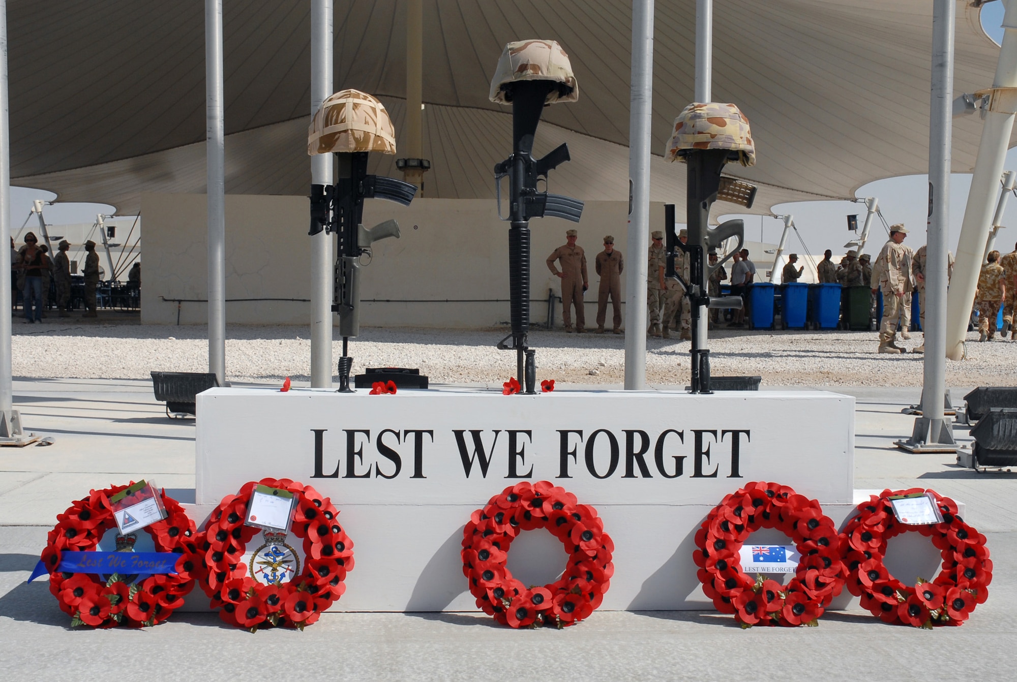 SOUTHWEST ASIA - Coalition forces from England, Australia and the United States gather to commemorate Remembrance Day and Veteran's Day Nov. 11 at a Southwest Asia air base. Prayers and invocations were delivered by chaplains from each country represented in various denominations. Poppy wreaths were laid at the memorial display by representatives of the countries. (U.S. Air Force photo by Staff Sgt. Douglas Olsen)
