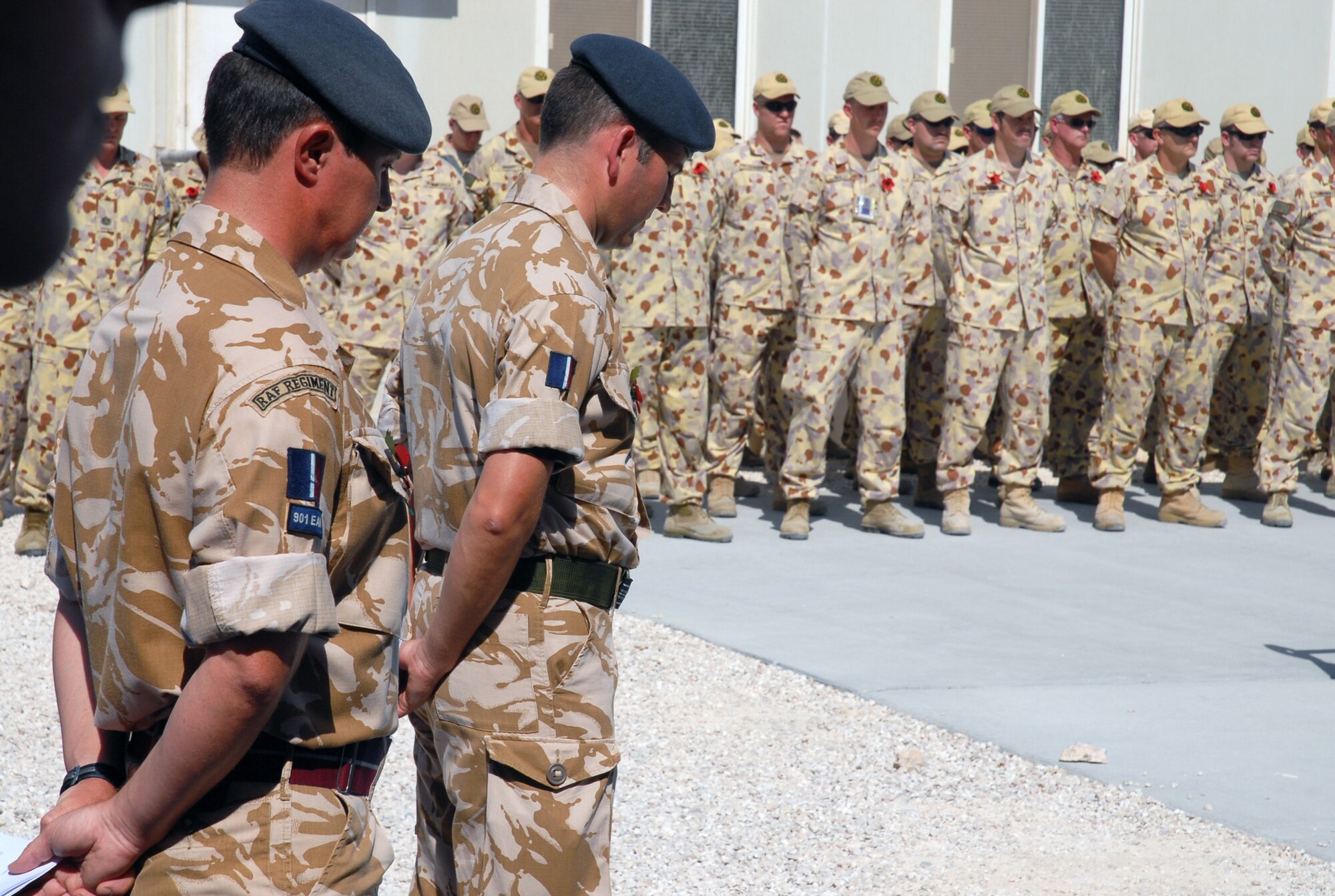 SOUTHWEST ASIA - Coalition forces from England, Australia and the United States gather to commemorate Remembrance Day and Veteran's Day Nov. 11 at a Southwest Asia air base. Prayers and invocations were delivered by chaplains from each country represented in various denominations. Wreaths were laid at the memorial by representatives of the countries. Leaders of the Royal Air Force detachment bow their heads during a prayer. (U.S. Air Force photo/ Staff Sgt. Douglas Olsen)