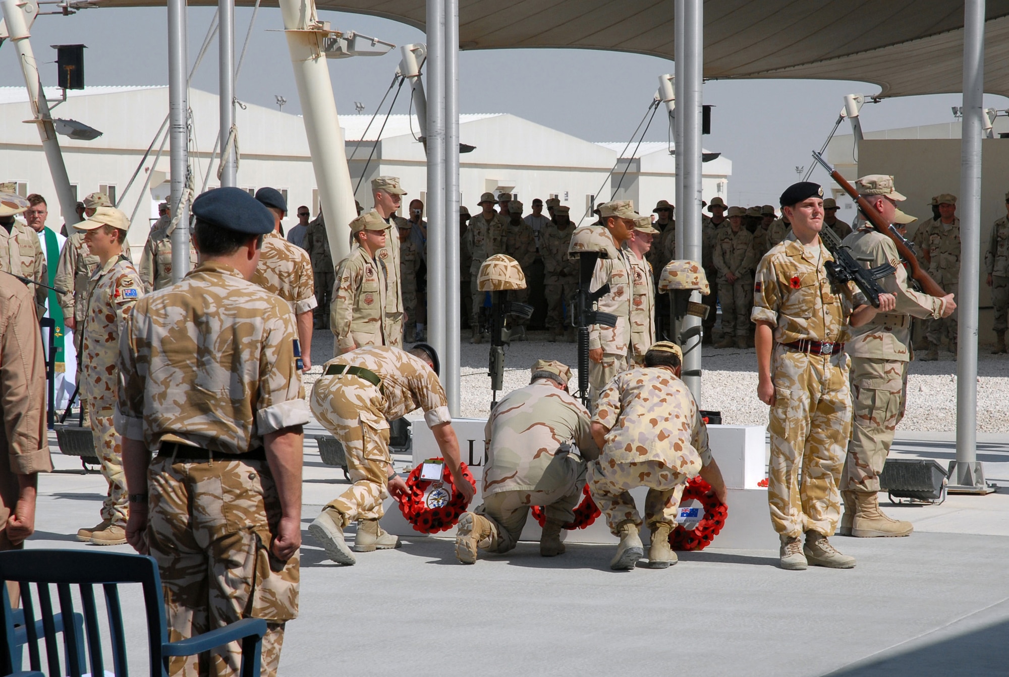SOUTHWEST ASIA - Coalition forces from England, Australia and the United States gather to commemorate Remembrance Day and Veteran's Day Nov. 11 at a Southwest Asia air base. Prayers and invocations were delivered by chaplains from each country represented in various denominations. Wreaths were also laid at the memorial by representatives of the countries. (U.S Air Force photo/Staff Sgt. Douglas Olsen)