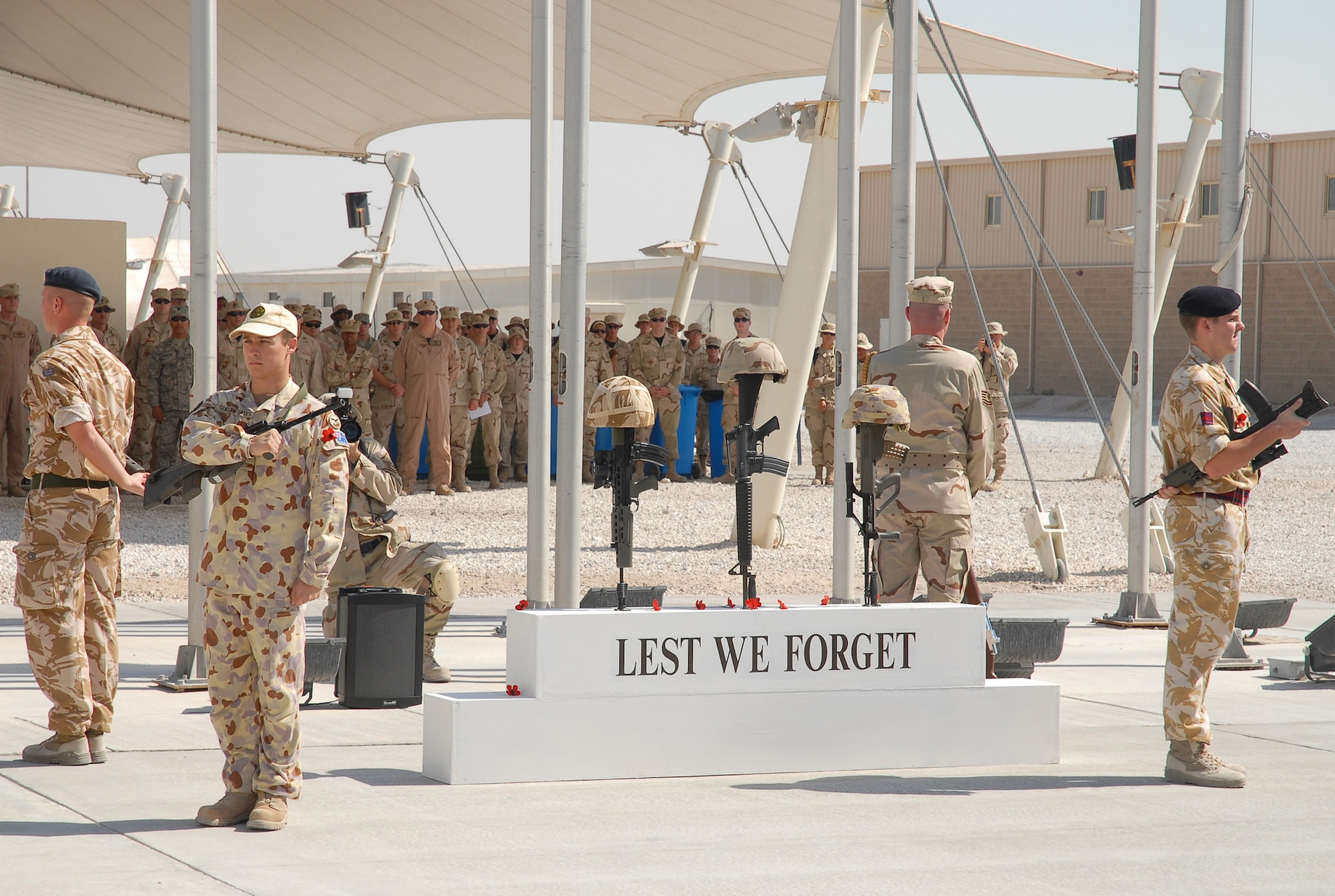SOUTHWEST ASIA - Coalition forces from England, Australia and the United States gather to commemorate Remembrance Day and Veteran's Day Nov. 11 at a Southwest Asia air base. Prayers and invocations were delivered by chaplains from each country represented in various denominations. Wreaths were laid at the memorial by representatives of the countries. (U.S. Air Force photo/Staff Sgt. Douglas Olsen)