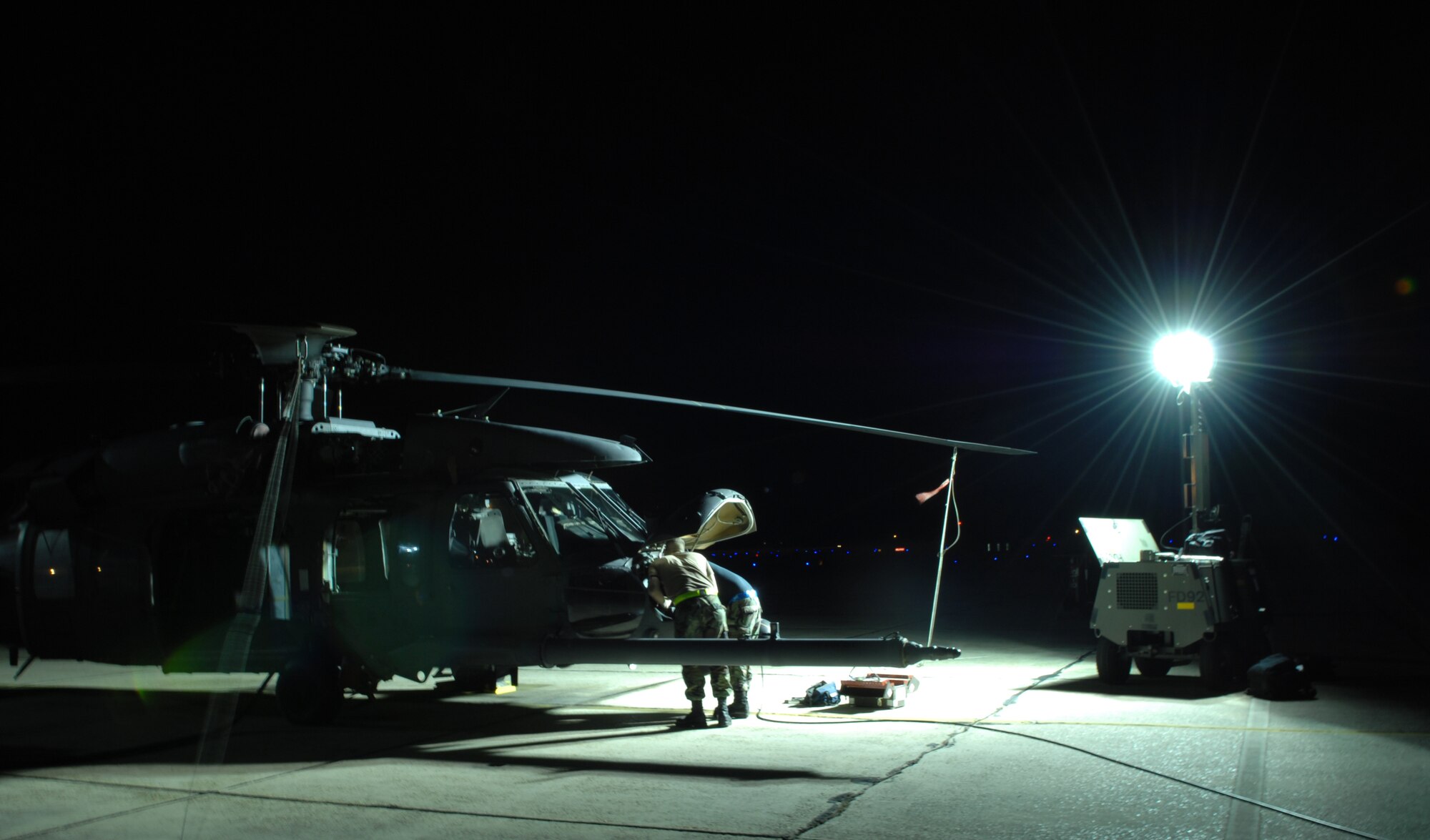 Senior Airman John Baia and Airman 1st Class Eric Dininger, 23rd
 Equipment Maintenance Squadron, work on an HH-60G Pave Hawk helicopter Oct. 31 at Moody Air Force Base, Ga. Moody Airmen work around the clock to ensure
flight success of the aircraft. (U.S. Air Force photo by Senior Airman
Elizabeth Rissmiller) 
