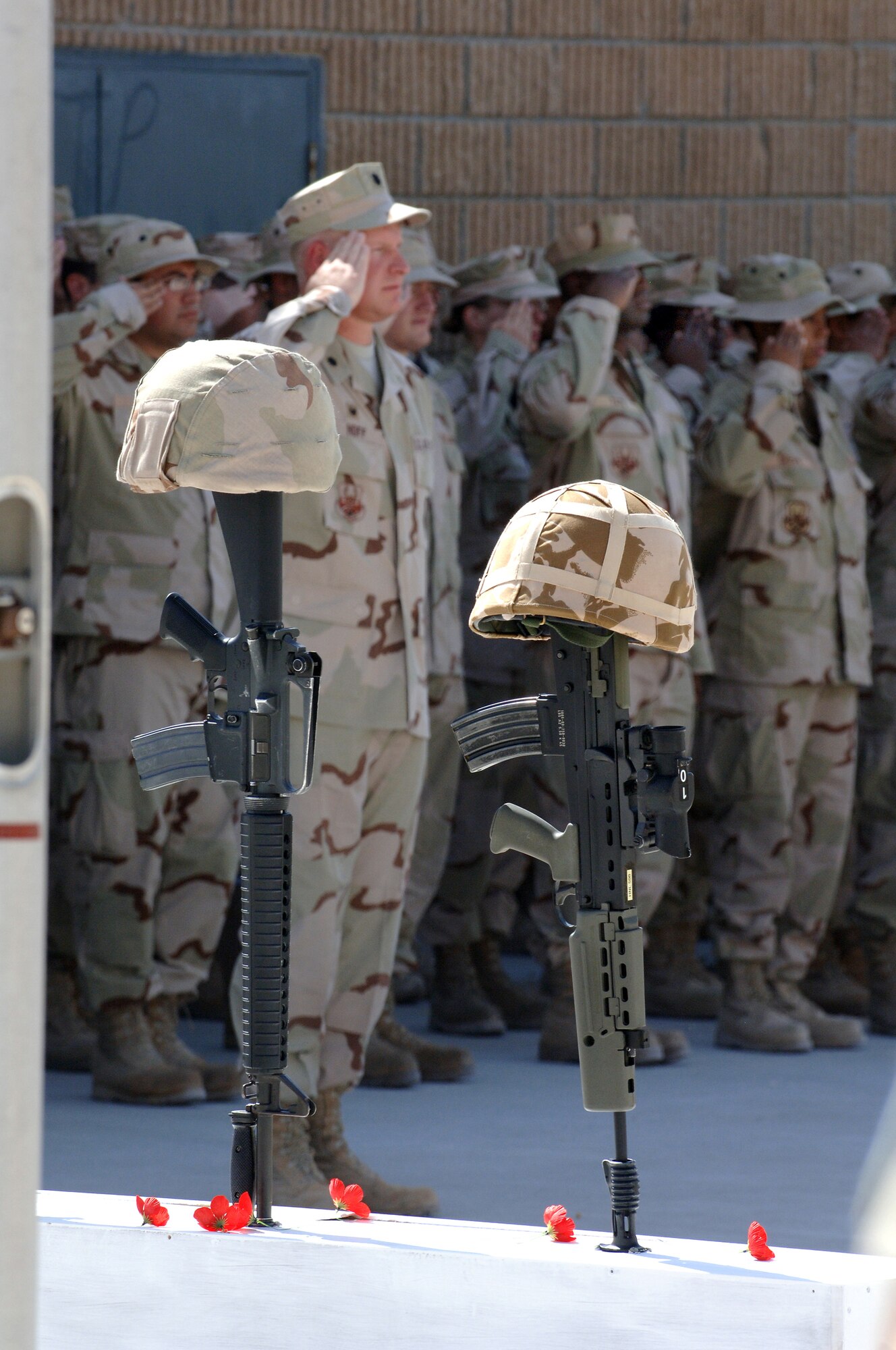 SOUTHWEST ASIA - Lt. Col. Robert Hoff, 379th Expeditionary Logistics Readiness commander, salutes along with other Air Force members in flight formation during the Remembrance Day and Veterans Day ceremony Nov. 11. at a southwest asia base.
(U. S. Air Force Photo/Master Sgt. Greg Kunkle)