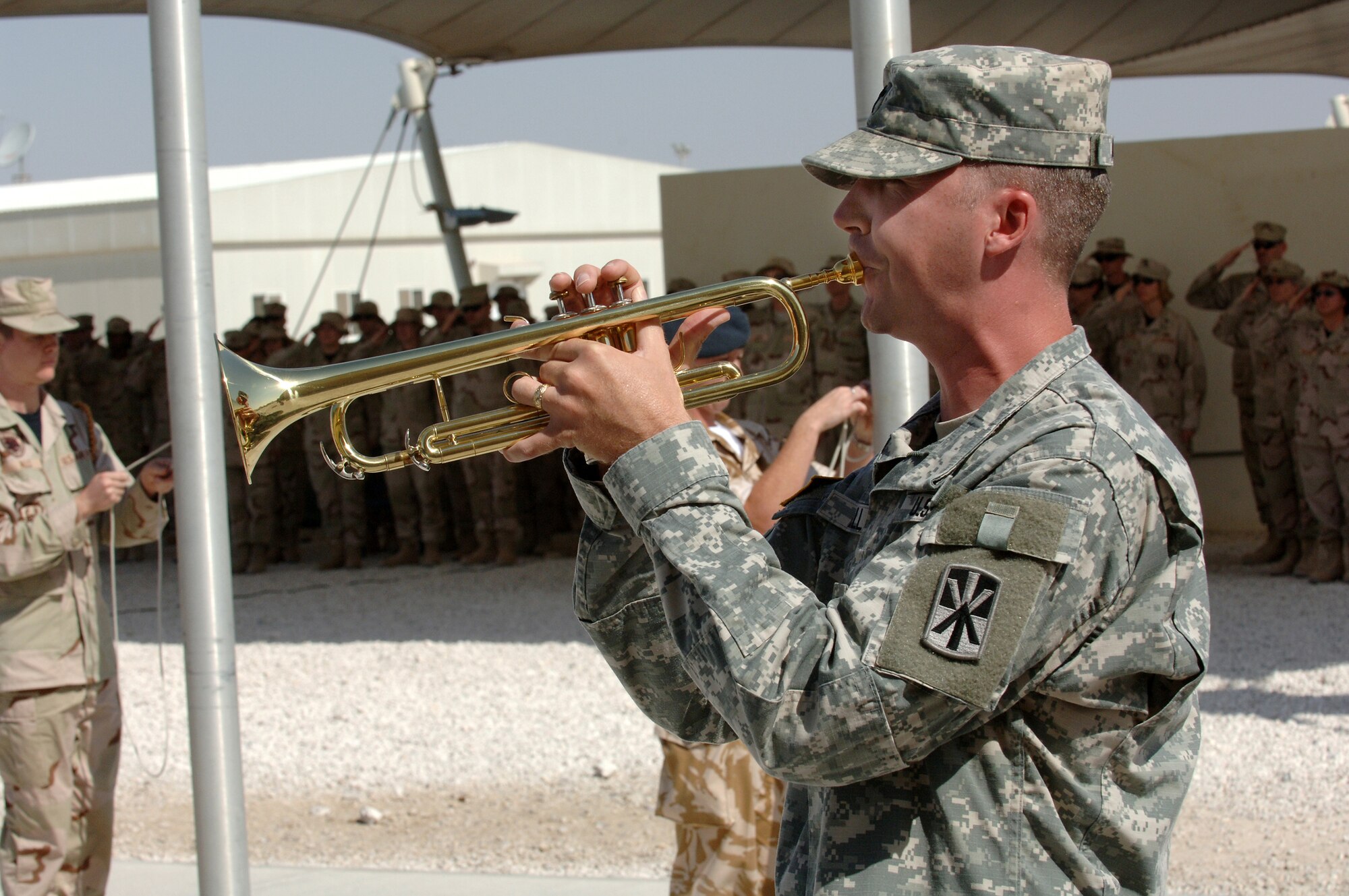 SOUTHWEST ASIA - Army Chaplain (Capt.) Troy Allan plays ceremonial music on the bugle during the Remembrance Day and Veterans Day cermony Nov.11 at a southwest asia base. (U.S. Air Force photo/Master Sgt. Greg Kunkle)

