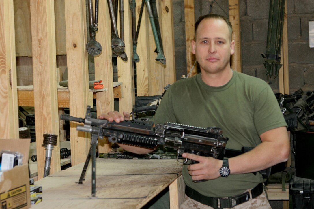 AL QA?IM, Iraq ? Cpl. Robert Jordan, the armory?s senior custodian for Company L of Task Force 3rd Battalion, 2nd Marine Regiment, Regimental Combat Team 2, stands with the M-249 semi-automatic weapon in the Company L armory at Camp Gannon, Husaybah, Iraq. Nearing his 40th birthday, Jordan craved the opportunity to once again wear the uniform of a United States Marine after leaving the Marine Corps almost 10 years ago.