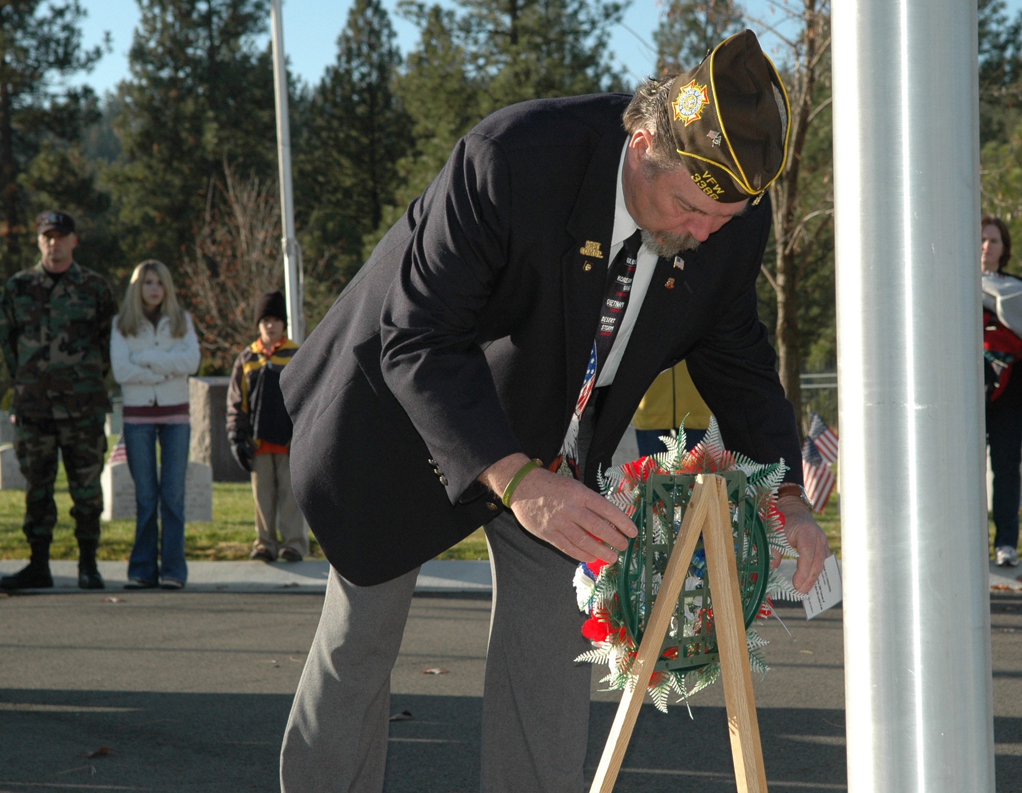 FAIRCHILD AIR FORCE BASE, Wash. -- Dave Guinsler, Veterans of Foreign War Horton/Strength Post 3386 senior vice commander, lays a wreath at the foot of the flagpole in the Fort Wright Cemetery during a Veterans Day ceremony Nov. 11. The wreath is to show respect for the men and women of the armed forces who have fallen in the past and to those who may fall in the future. (U.S. Air Force photo / Tech. Sgt. Larry W. Carpenter Jr.)