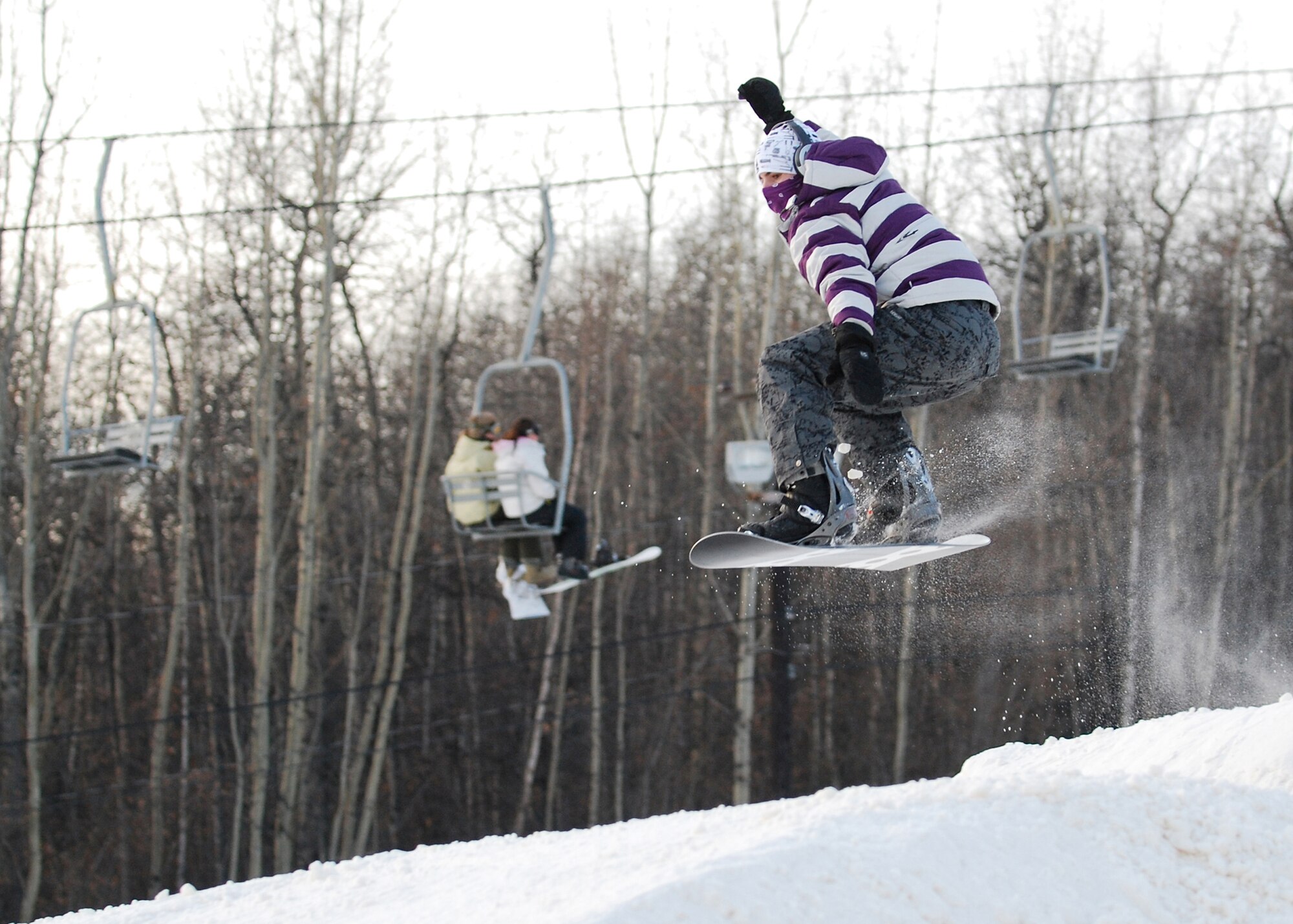 EIELSON AIR FORCE BASE, Alaska-- Senior Airman Michael Burch, 354th Communications Squadron wideband satellite tactical systems journeyman, launches off a jump Nov. 11 during Birch Hill's opening weekend. Birch Hill is the local skiing and snowboarding recreational area, located at Fort Wainwright. Other events held at Birch Hill are tubing and skeet shooting. (U.S. Air Force photo by Senior Airman Mark Eidschun)