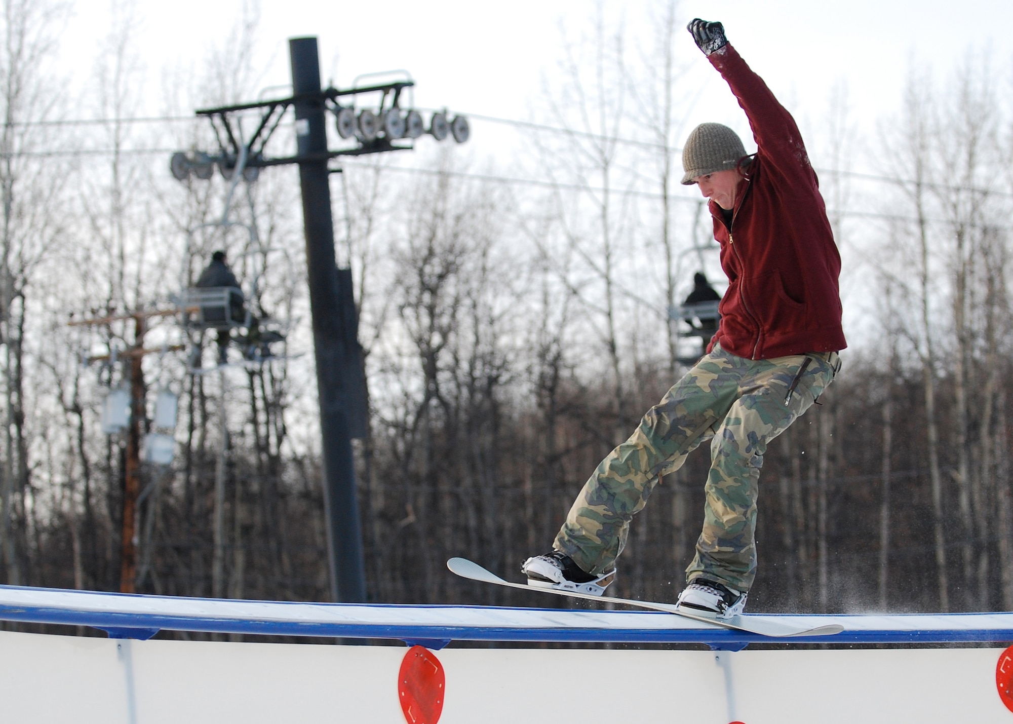 EIELSON AIR FORCE BASE, Alaska-- Airman 1st Class Chase Doyel, 354th Aircraft Maintenance Squadron crew chief, grinds a C-rail Nov. 11 during Birch Hill's opening weekend. Birch Hill is the local skiing and snowboarding recreational area, located at Fort Wainwright. Other events held at Birch Hill are tubing and skeet shooting. (U.S. Air Force photo by Senior Airman Mark Eidschun)