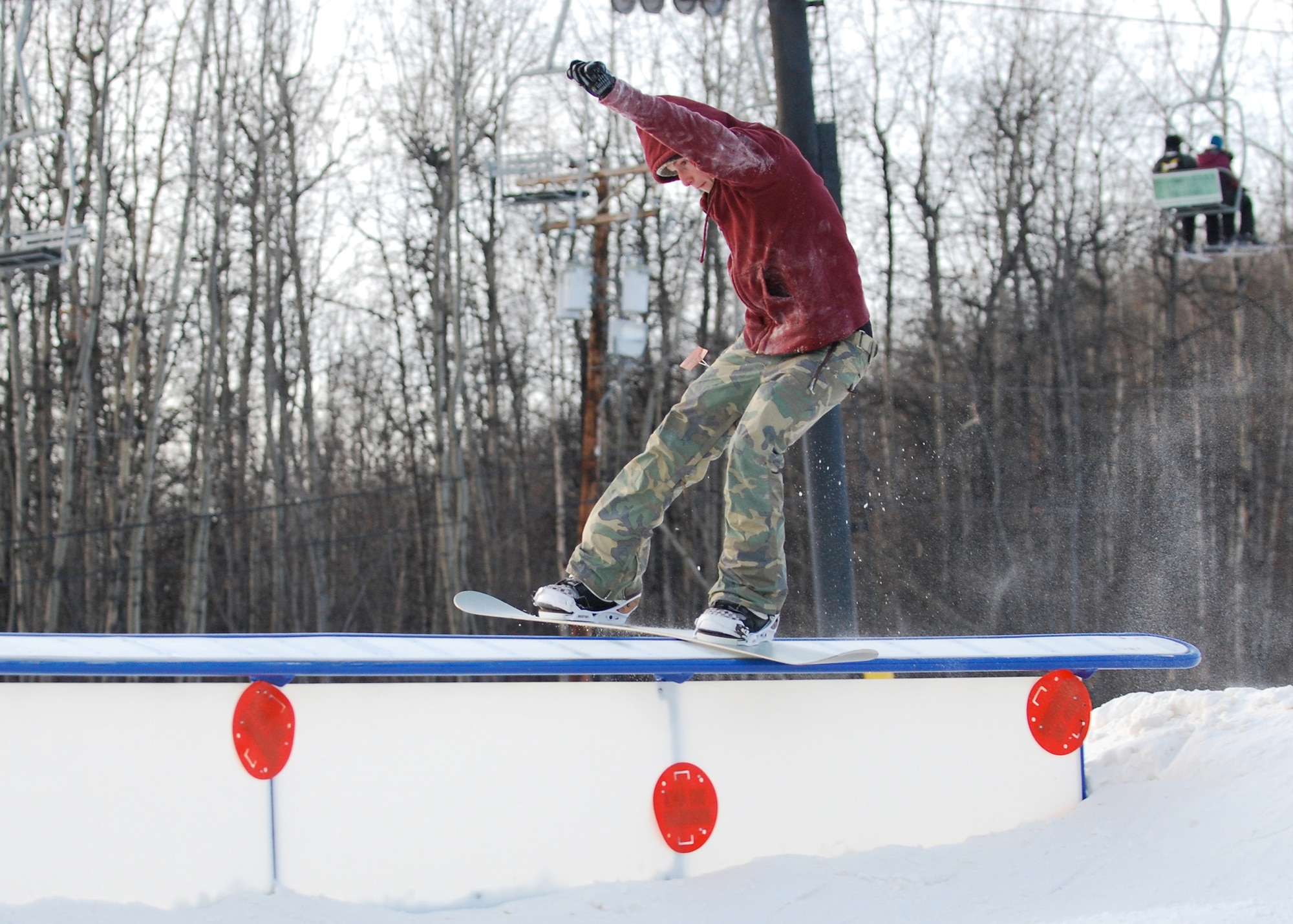 EIELSON AIR FORCE BASE, Alaska-- Airman 1st Class Chase Doyel, 354th Aircraft Maintenance Squadron crew chief, grinds a rail Nov. 11 during Birch Hill's opening weekend. Birch Hill is the local skiing and snowboarding recreational area, located at Fort Wainwright. Other events held at Birch Hill are tubing and skeet shooting. (U.S. Air Force photo by Senior Airman Mark Eidschun)