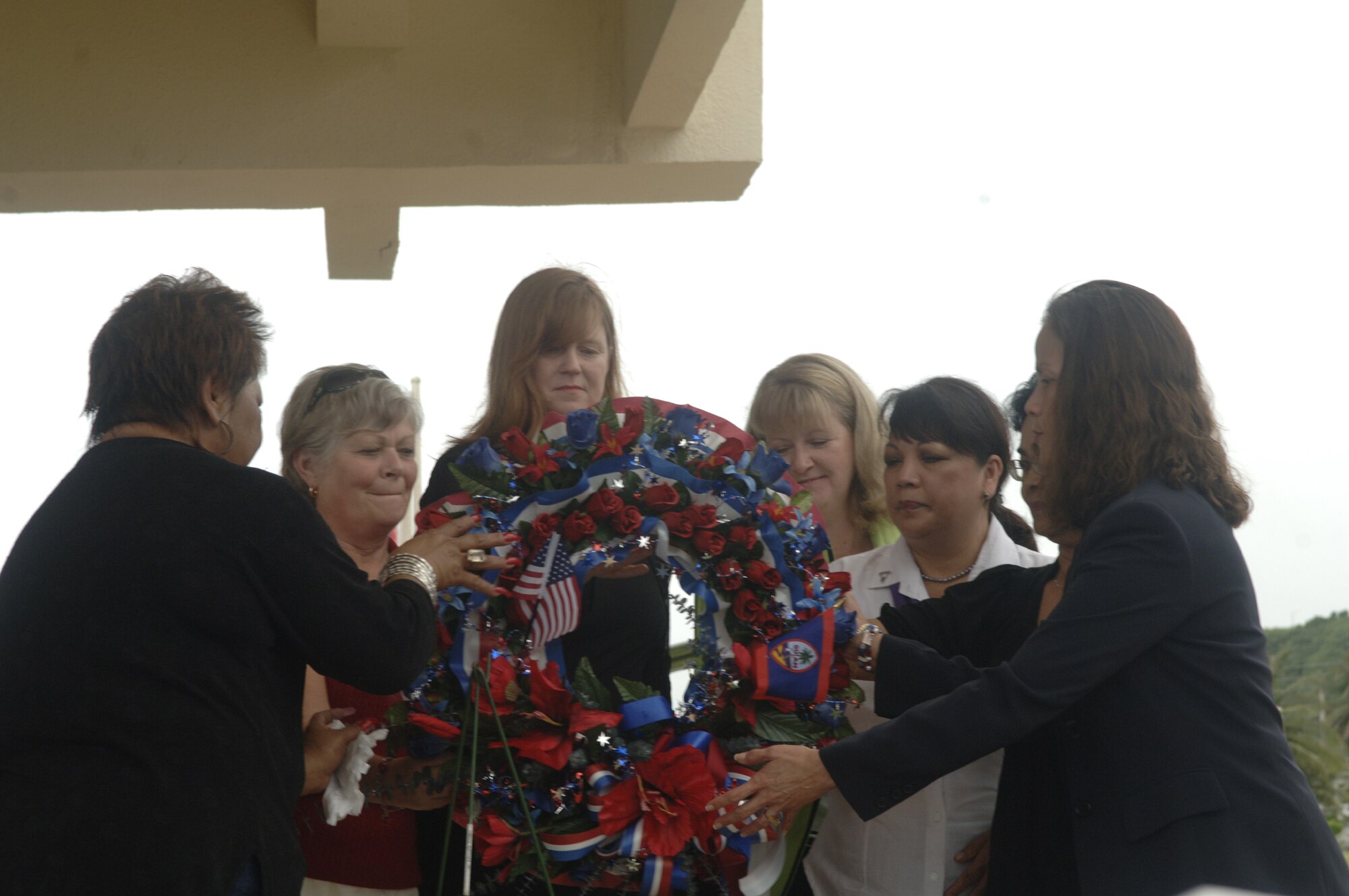 First Lady Joanne Camacho, Mrs. Douglas Owens, Mrs. Kristen Galbreath, Mrs. Donald Goldhorn, Mrs. Antonio Unpingco, and members of the Ladies Auxiliaries participate in the Wreath Laying ceremony in honor of veterans who have gone before.