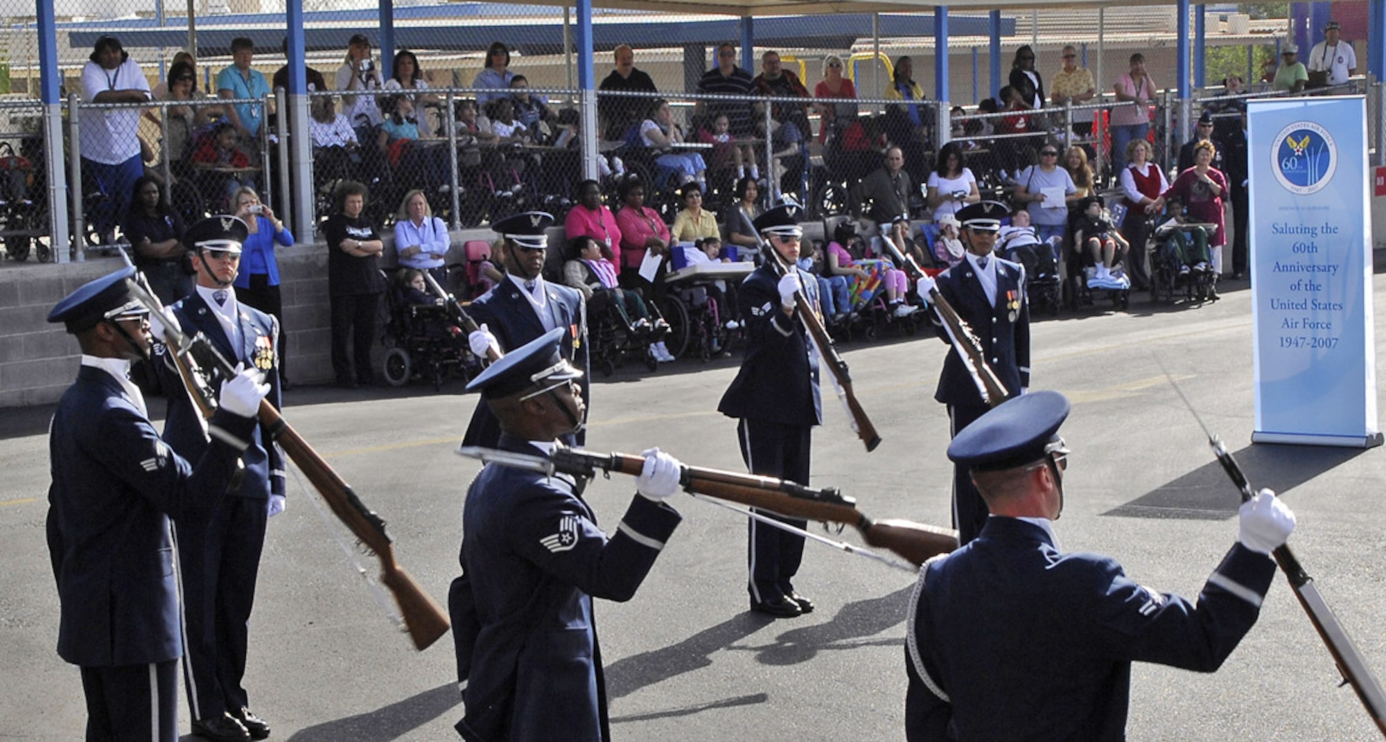 Members of the Air Force Honor Guard drill team perform at the John F. Miller School for Special Needs Nov. 8 in Las Vegas. The drill team planned a special performance for the students at the school during their visit to the city and Nellis Air Force Base, Nev., for the final week of the Air Force's 60th Anniversary celebrations. (U.S. Air Force photo/Airman 1st Class Alexander Montes) 
