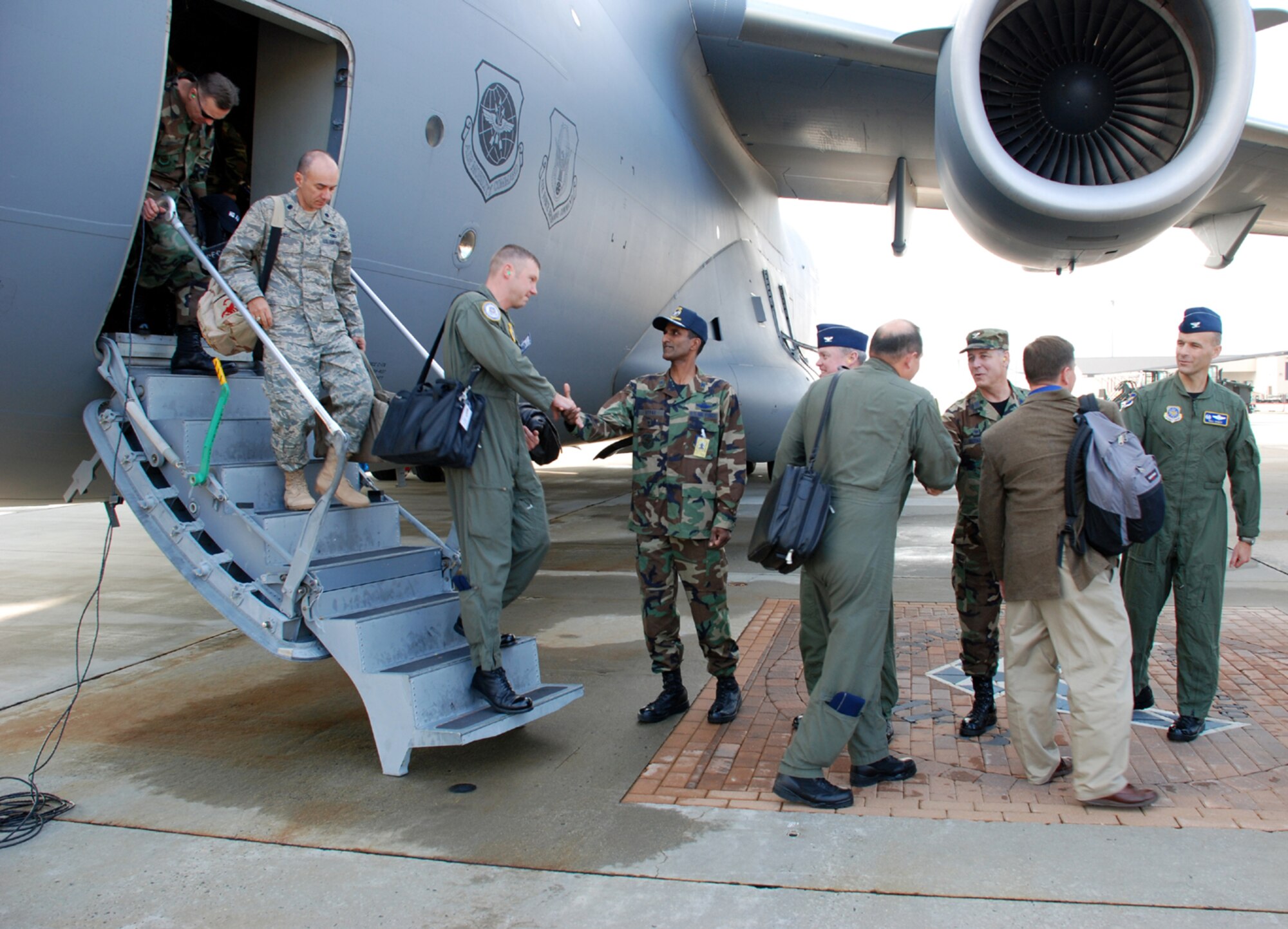 Col. Balan Ayyar, 305th Air Mobility Wing commander, and other Team McGuire leadership, greet the Air Mobility Command Inspector General Team as they arrive here Nov. 13. The McGuire Unit Compliance Inspection will continue through Nov. 18. (U.S. Air Force photo/Airman 1st Class Rebekah Phy)