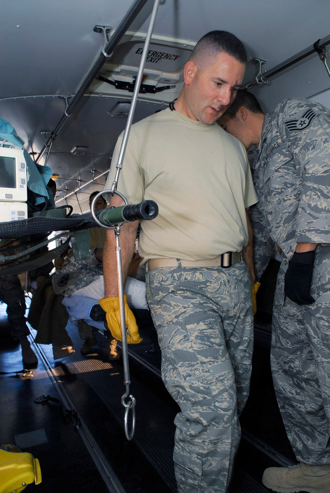 Tech. Sgt. Adam Page loads a patient on an ambulance bus Nov. 13 at Balad Air Base, Iraq. Patients heading to Germany for additional medical care process through the Contingency Aeromedical Staging Facility before boarding a C-17 Globemaster III for the flight. Sergeant Page, assigned to the 332nd Expeditionary Aerospace Medical Squadron, is deployed from Travis Air Force Base, Calif. (U.S. Air Force photo/Staff Sgt. Joshua Garcia) 
