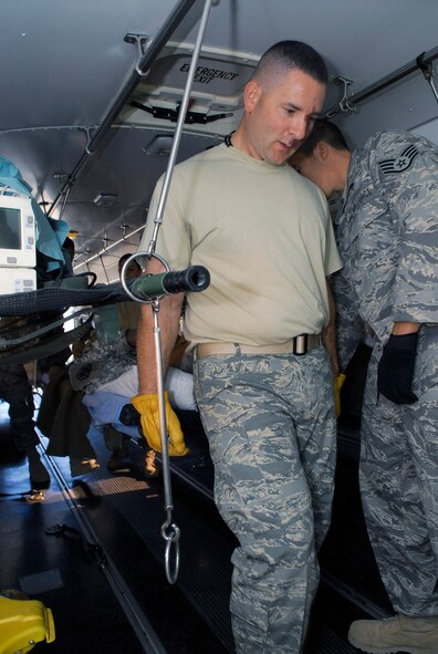 Tech. Sgt. Adam Page loads a patient on an ambulance bus Nov. 13 at Balad Air Base, Iraq. Patients heading to Germany for additional medical care process through the Contingency Aeromedical Staging Facility before boarding a C-17 Globemaster III for the flight. Sergeant Page, assigned to the 332nd Expeditionary Aerospace Medical Squadron, is deployed from Travis Air Force Base, Calif. (U.S. Air Force photo/Staff Sgt. Joshua Garcia) 
