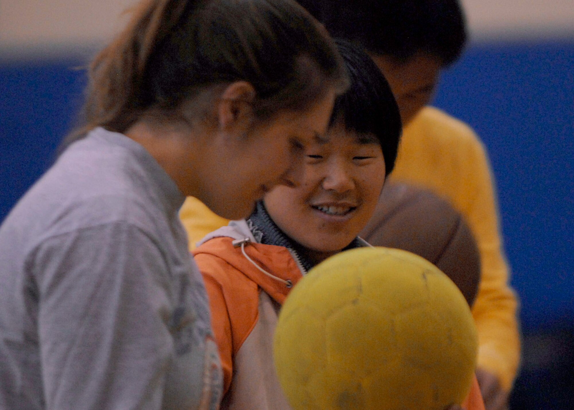 Senior Airman Lindsay DeReadt interacts with a young girl at the fitness center Nov. 10 at Kunsan Air Base, South Korea. Airmen held a day of games and food for the local nationals. The good neighbor program is designed for the base to actively engage with the local community to strengthen ties. Airman DeReadt is a 8th Communications Squadron military postal clerk. (U.S. Air Force photo/Staff Sgt. Araceli Alarcon) 
