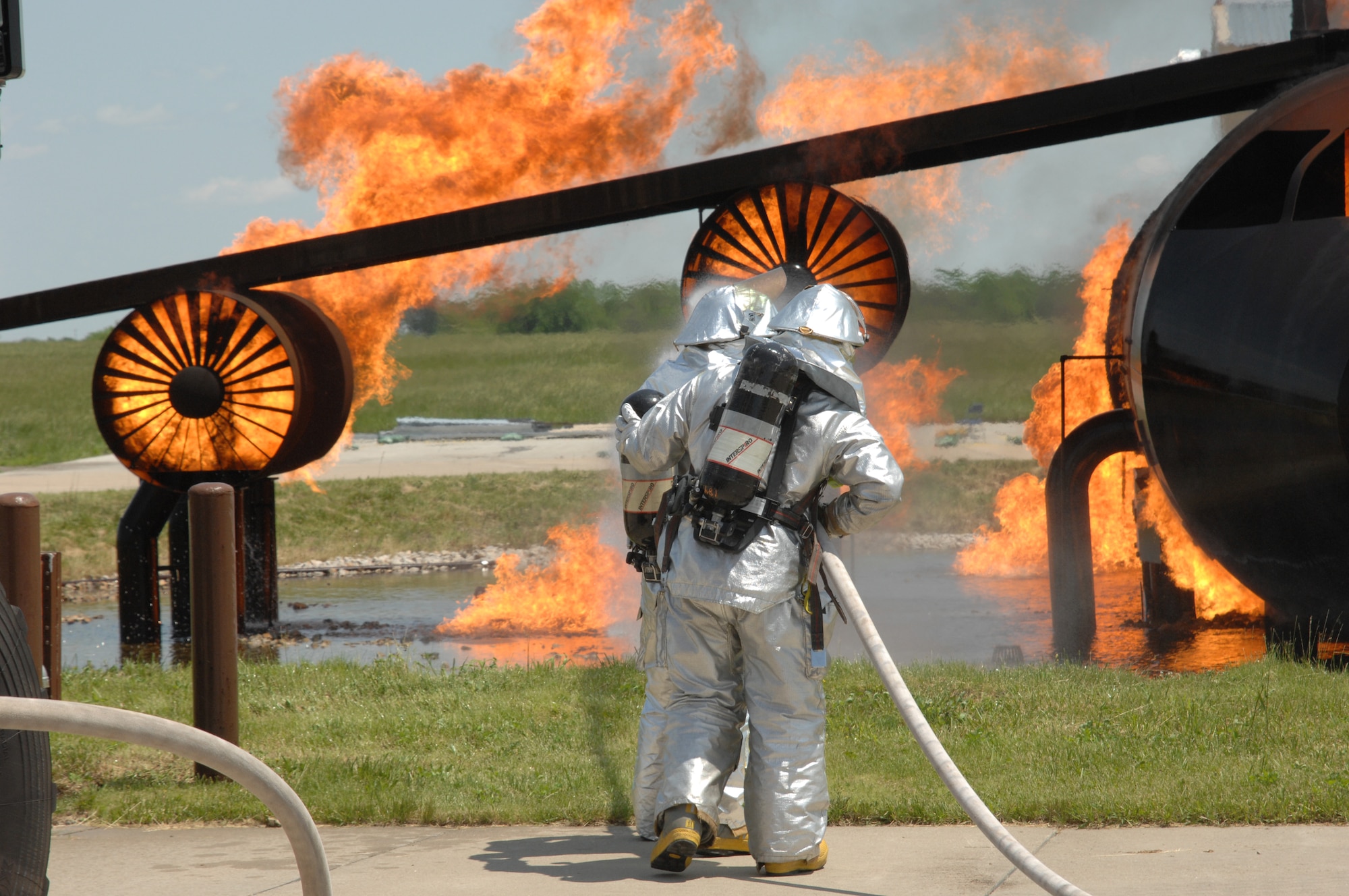 WHITEMAN AIR FORCE BASE, Mo. -- Members of the 509th Civil Engineer Squadron Fire Department put out an aircraft fire at the training pit during the Conventional Operation Readiness Inspection May 16. (U.S. Air Force photo/Tech. Sgt. Samuel A. Park)