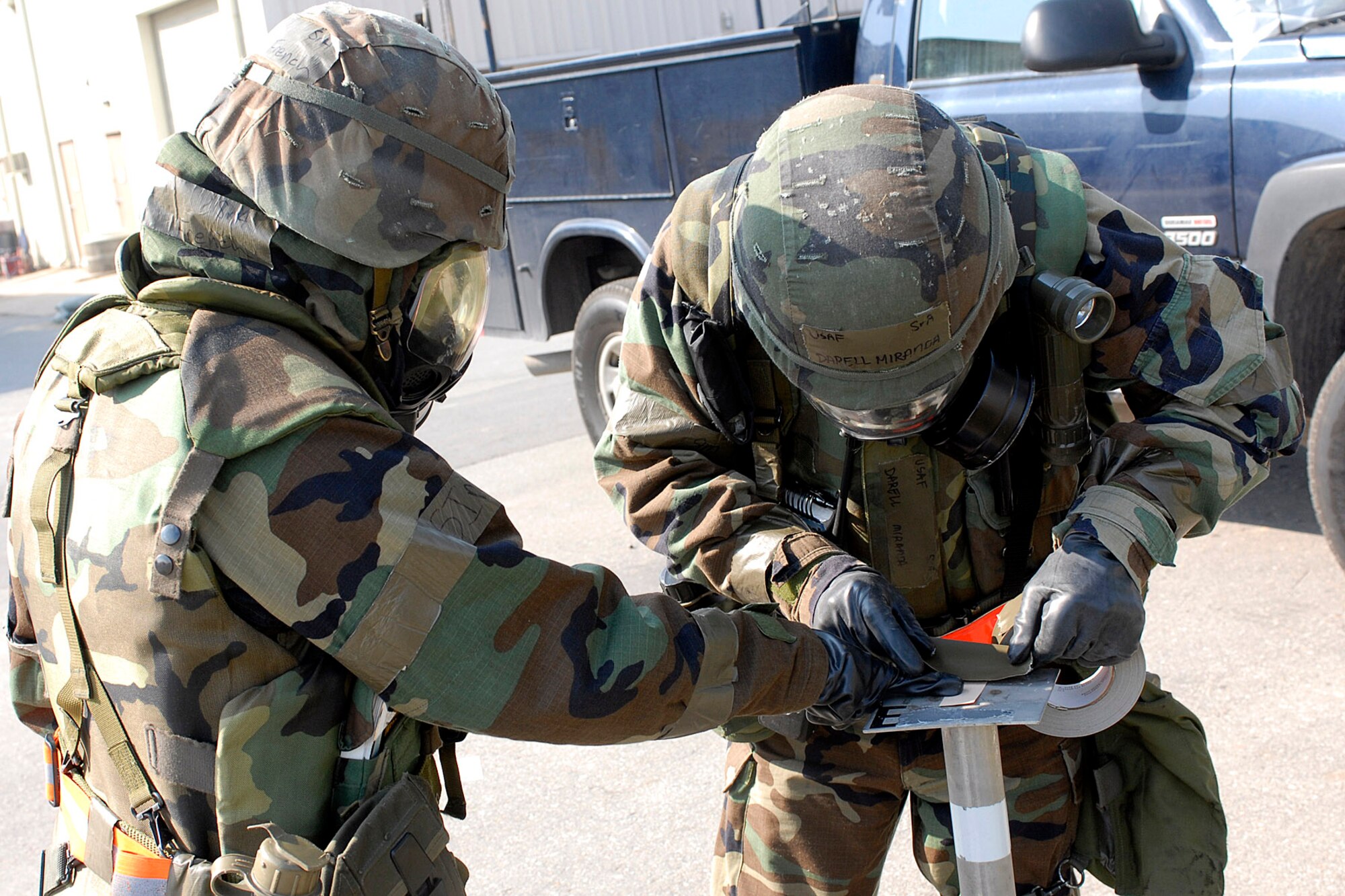 Senior Airmen Darrell Miranda and Manda French check M-8 paper for signs of possible chemical contamination during a general release after a simulated missile attack during the Peninsula Operational Readiness Exercise Nov. 8 at Kunsan Air Base, South Korea. The exercise was conducted to ensure base members remain ready to execute its mission. Airmen French and Miranda are assigned to the 8th Civil Engineer Squadron. (U.S. Air Force photo/Senior Airman Giang Nguyen) 

