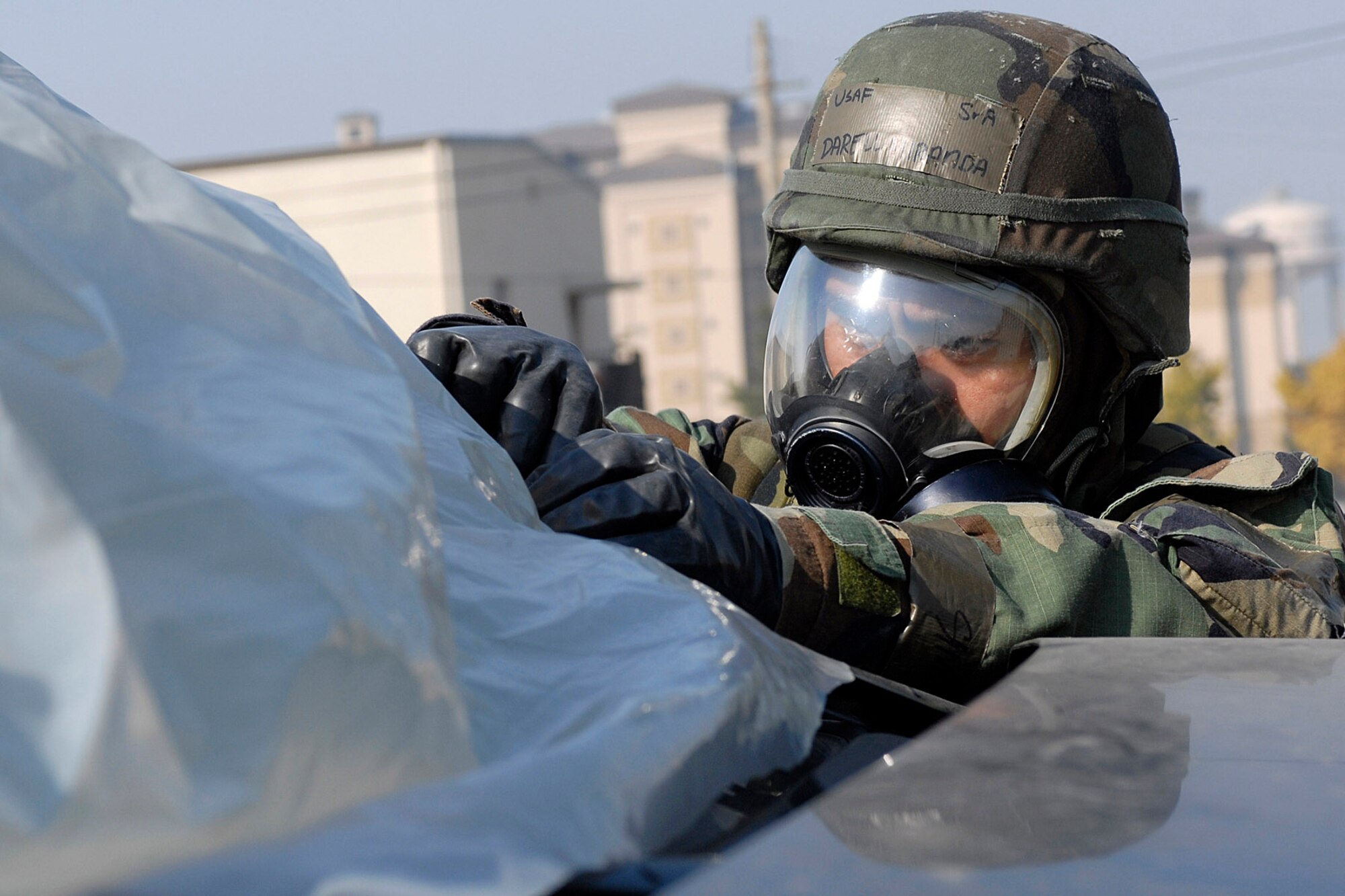 Senior Airman Darrell Miranda covers up a vehicle with plastic wrapping to avoid contamination during the Peninsula Operational Readiness Exercise Nov. 8 at Kunsan Air Base, South Korea. The exercise was conducted to ensure base members remain ready to execute its mission. Airman Miranda is assigned to the 8th Civil Engineer Squadron. (U.S. Air Force photo/Senior Airman Giang Nguyen) 
