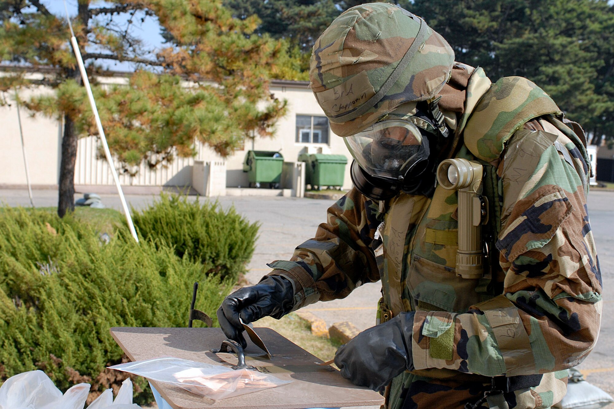 Senior Airman Argelio Chappotin checks M-8 paper during a general release after a simulated missile attack during the Peninsula Operational Readiness Exercise Nov. 8 at Kunsan Air Base, South Korea. The exercise was conducted to ensure base members remain ready to execute its mission. Airman Chappotin is assigned to the 8th Civil Engineer Squadron. (U.S. Air Force photo/Senior Airman Giang Nguyen) 

