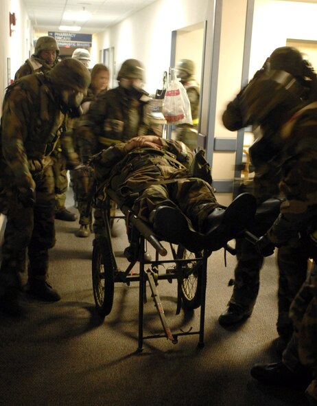 8th Medical Operations Squadron members rush a cardiac arrest victim in a simulated exercise during the Peninsula Operational Readiness Exercise Nov. 7 at Kunsan Air Base, South Korea. The exercise is conducted to ensure base members remain ready to execute its mission. (U.S. Air Force photo/Senior Airman Steven R. Doty) 