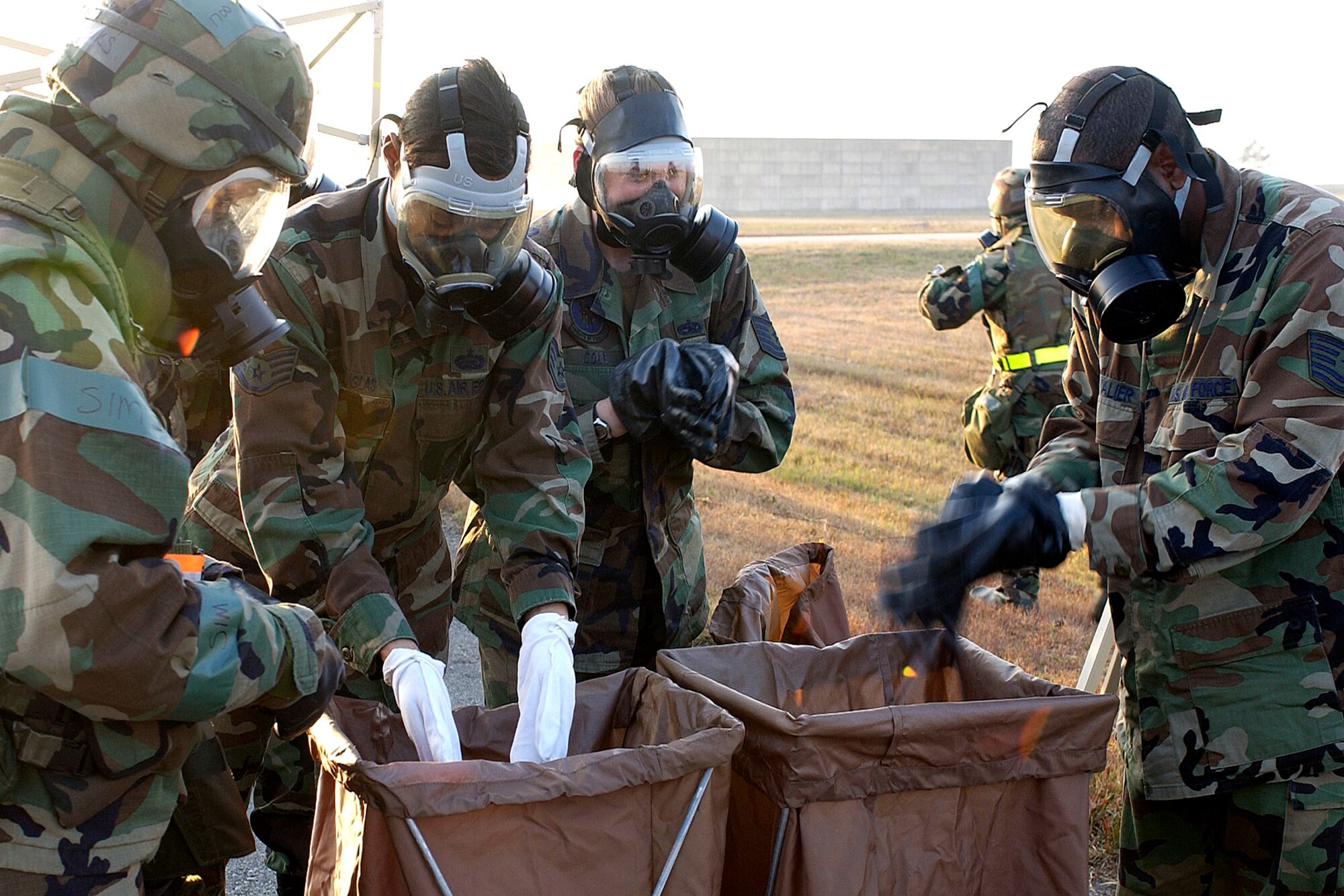 Airmen dispose of their contaminated gears during the Peninsula Operational Readiness Exercise Nov. 7 at Kunsan Air Base, South Korea. The exercise was conducted to ensure base members remain ready to execute its mission. (U.S. Air Force photo/Senior Airman Giang Nguyen) 

                               