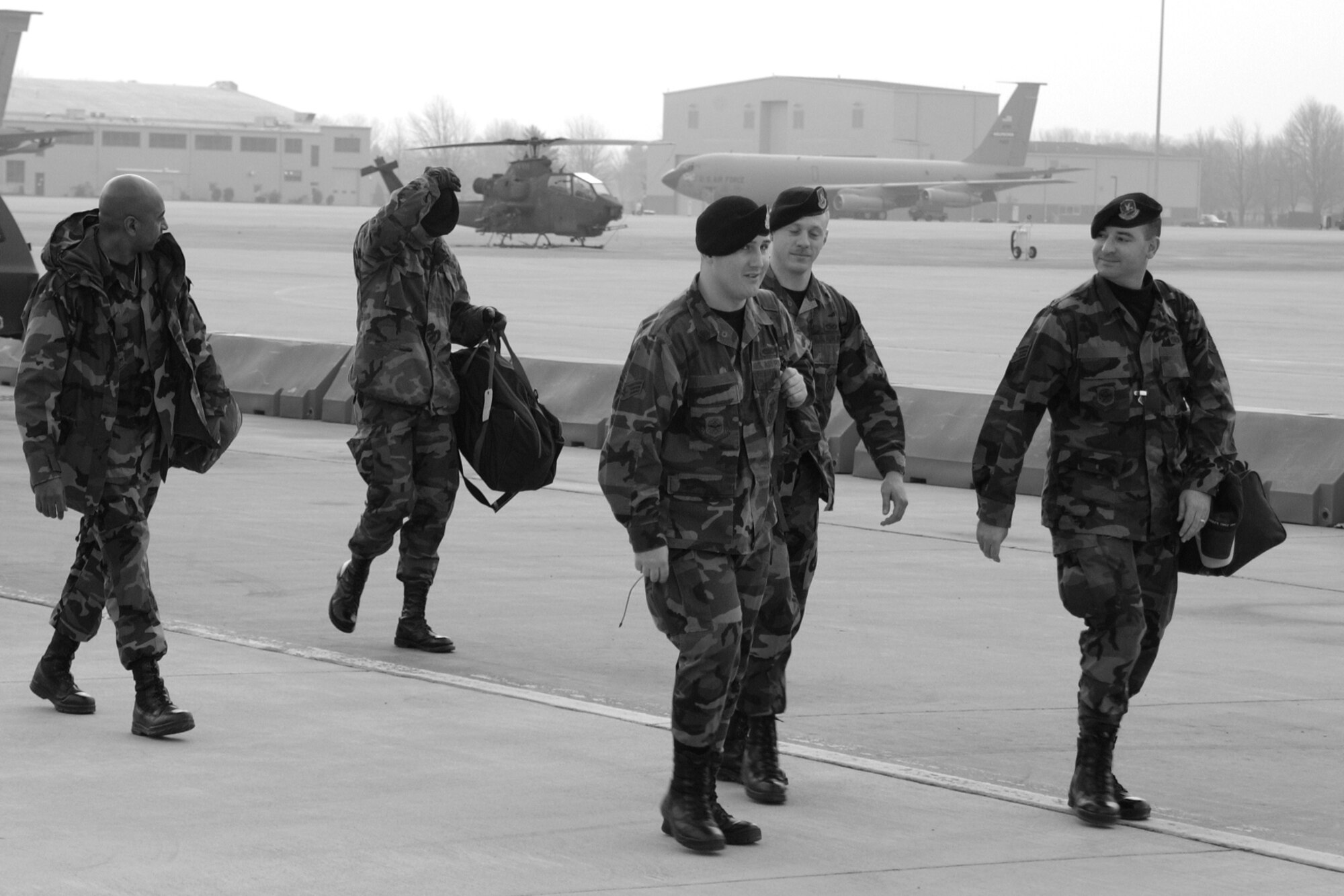 Airmen from 927th Security Forces Squadron, assigned to 927th Air Refueling Wing, Air Force Reserve Command, leave their families and loved ones behind as they head for an awaiting KC-135 to transport them on the first leg of flights to their forward deployed location.