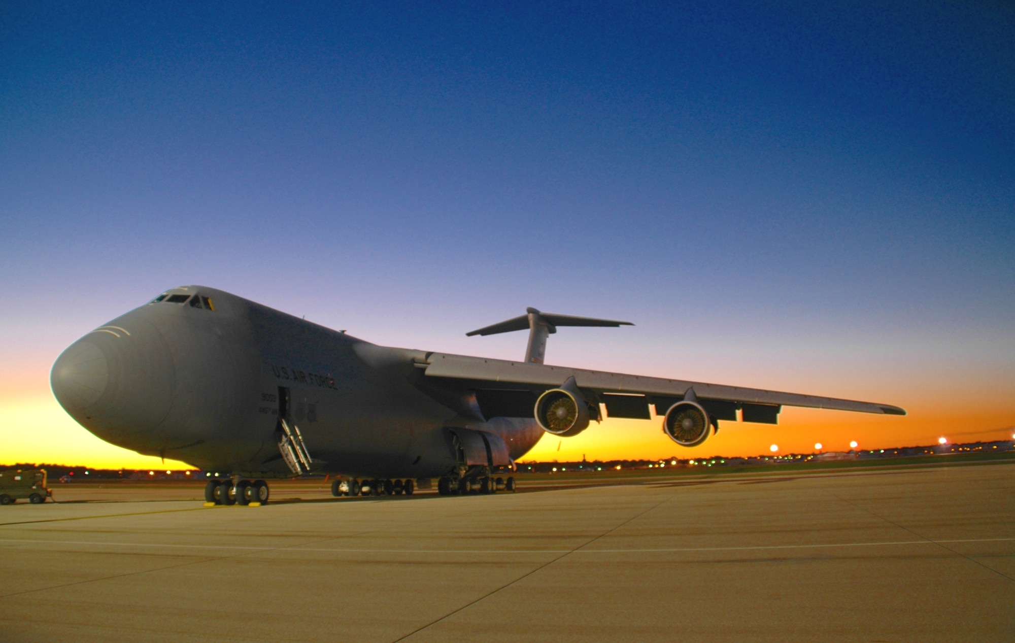 WRIGHT-PATTERSON AFB, Ohio - A C-5 Galaxy sits on the 445th Airlift Wing's West Ramp as the sun rises in the background. (U.S. Air Force photo(color enhanced) / TSgt Charlie Miller)